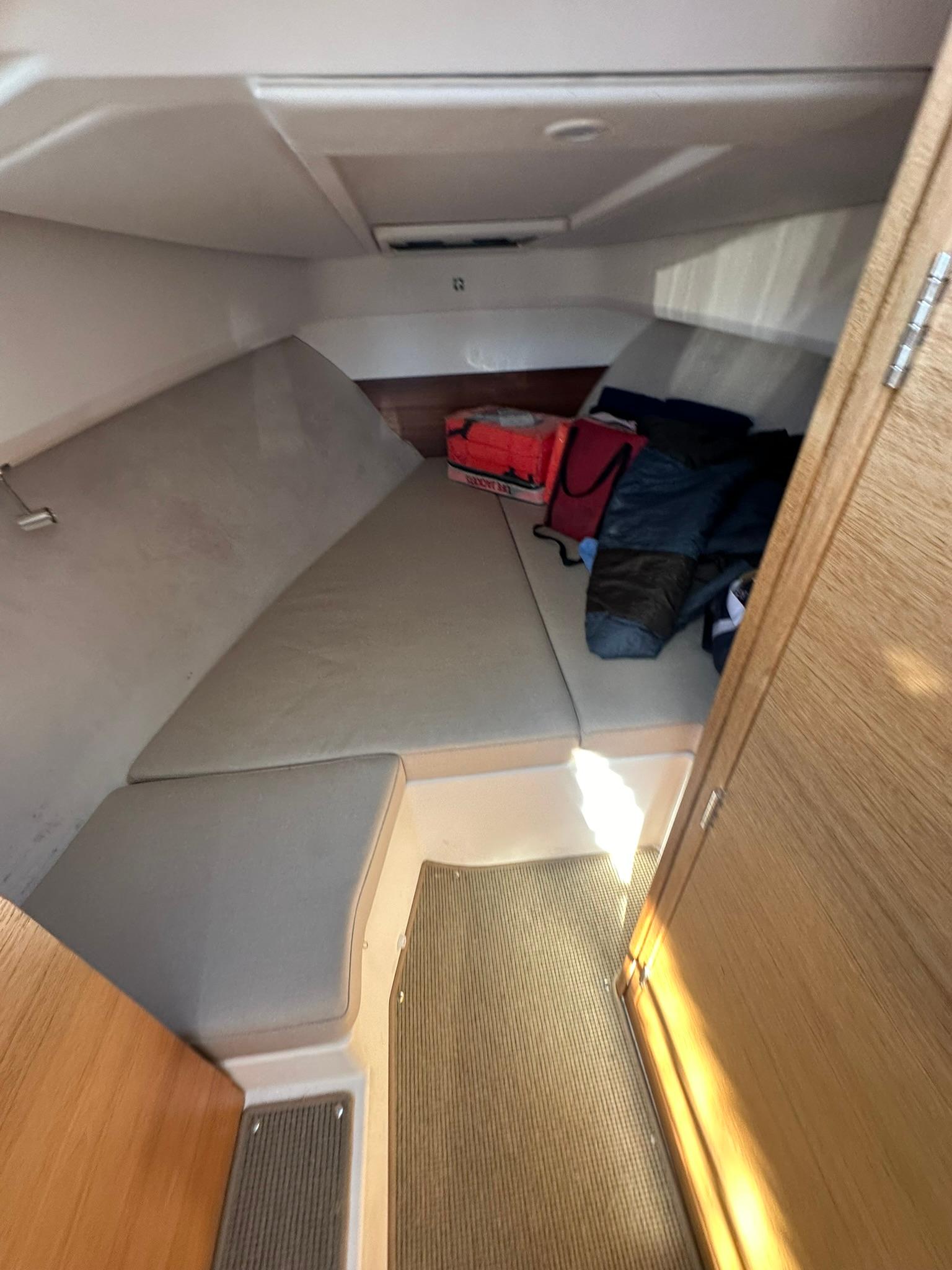 Cozy cabin interior of 2021 Nimbus W9 boat with seating and storage.