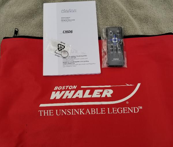 Red Boston Whaler bag with manual, remote, and keychain for 2011 235 Conquest boat.