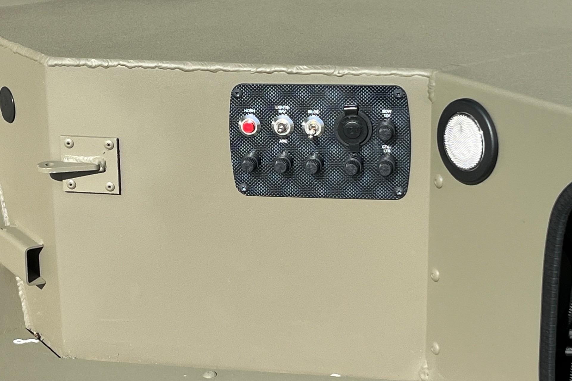Control panel on 2026 Tracker Grizzly 1654 T Sportsman boat, featuring switches and buttons.