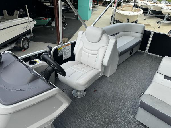 2023 Godfrey 2286 boat interior with captain's chair and seating area.