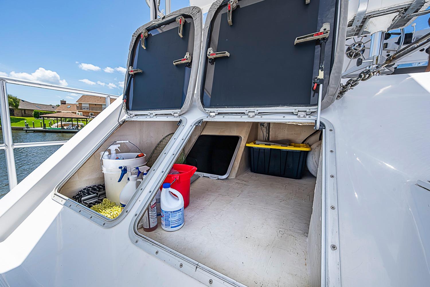 Storage compartments on a 2003 Magna Marine Nova Scotia 47 boat, containing cleaning supplies.