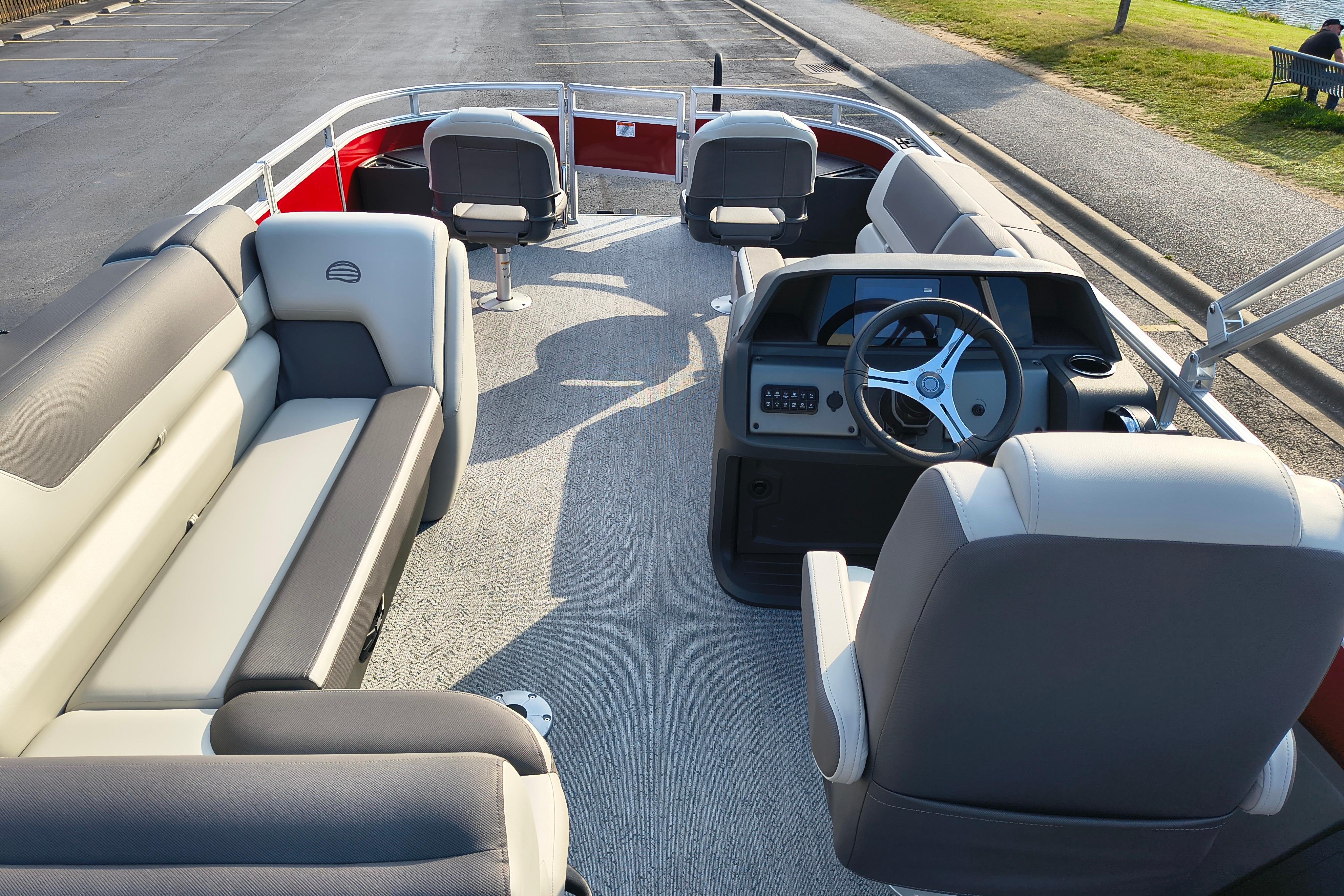 2026 Sun Tracker Fishin' Barge 22 DLX interior with spacious seating and steering console.