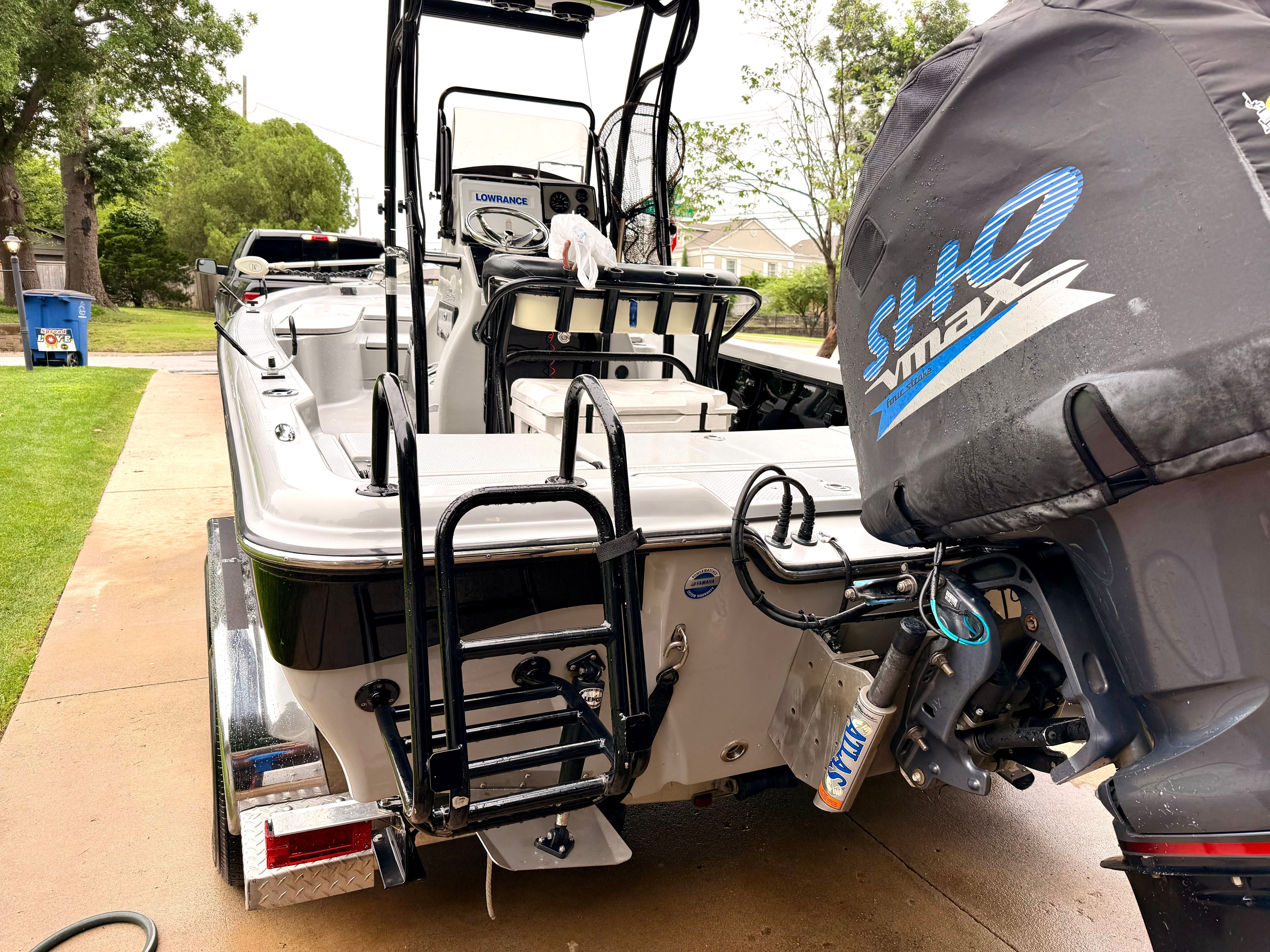 A 2013 Blue Wave Pure Bay 2200 boat on a trailer, featuring a Yamaha outboard motor.
