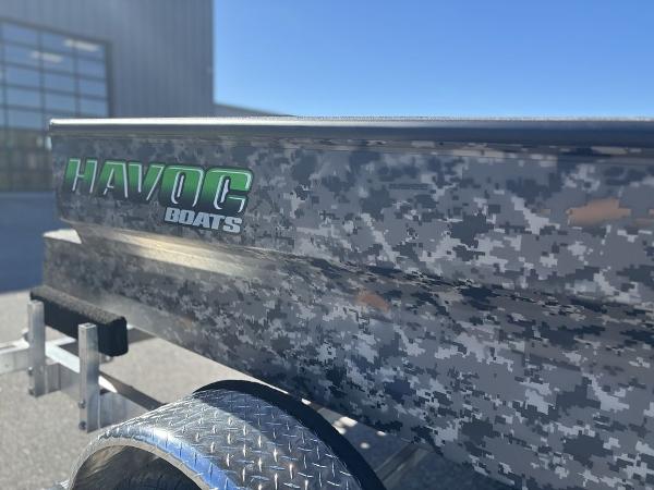 2025 Havoc 1656 VJST boat with digital camouflage design and logo, parked outdoors.