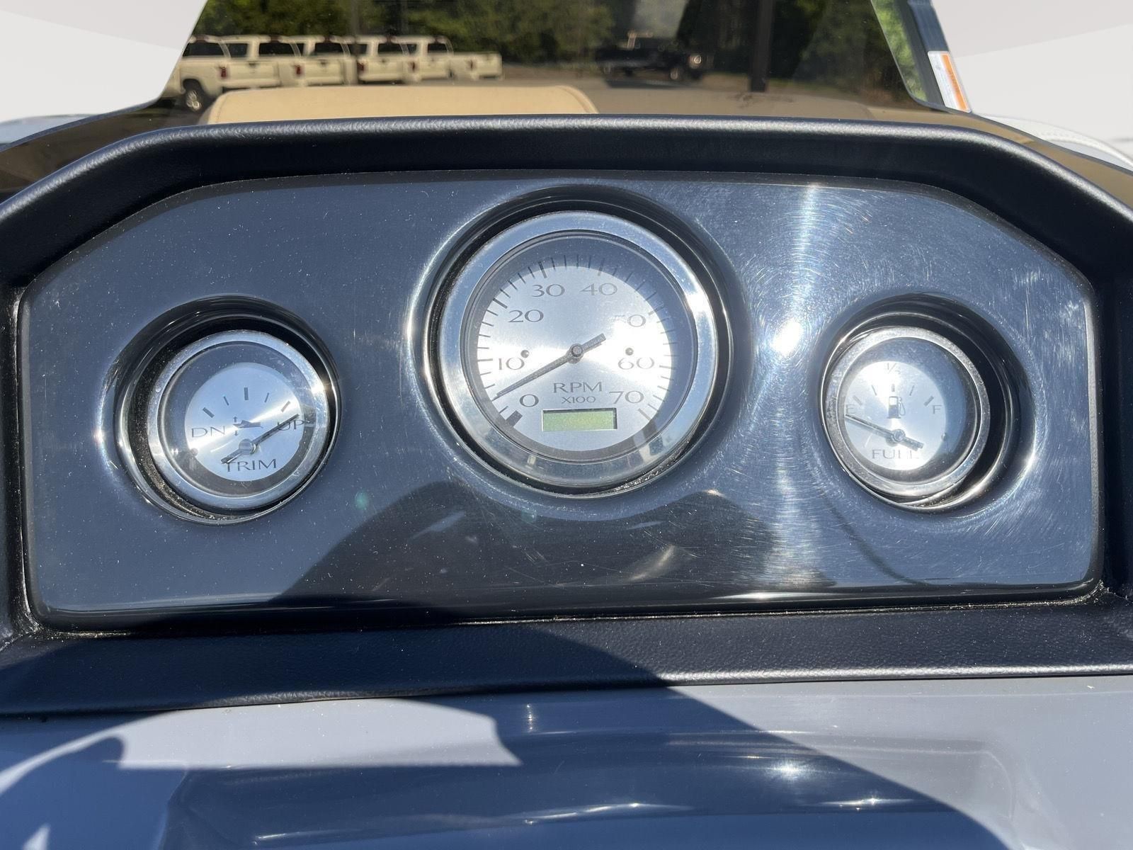 Close-up of a Bennington S20 boat dashboard with three round gauges.