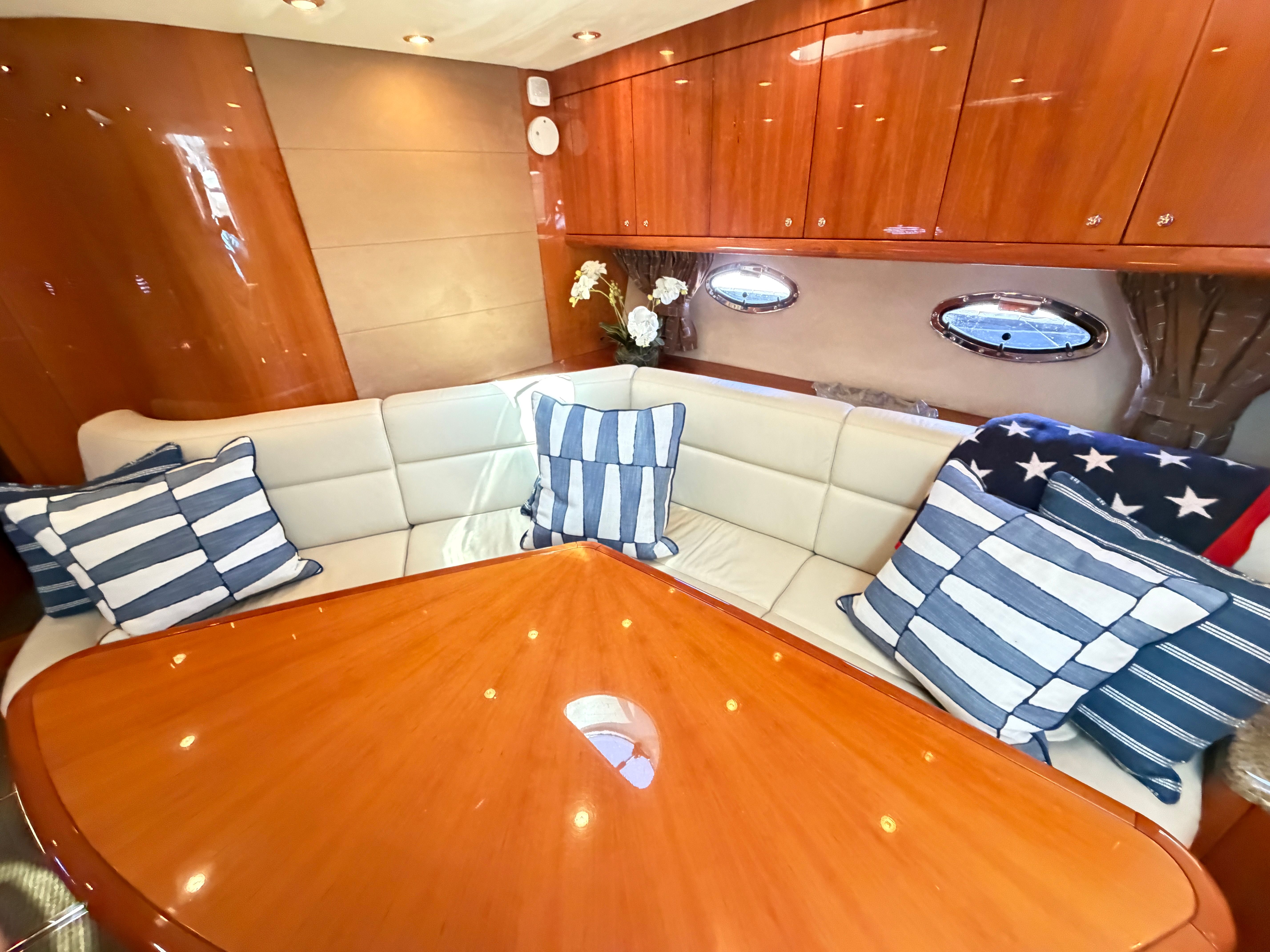 Interior of a 2008 Sunseeker Portofino 53 with elegant seating area and wooden table.