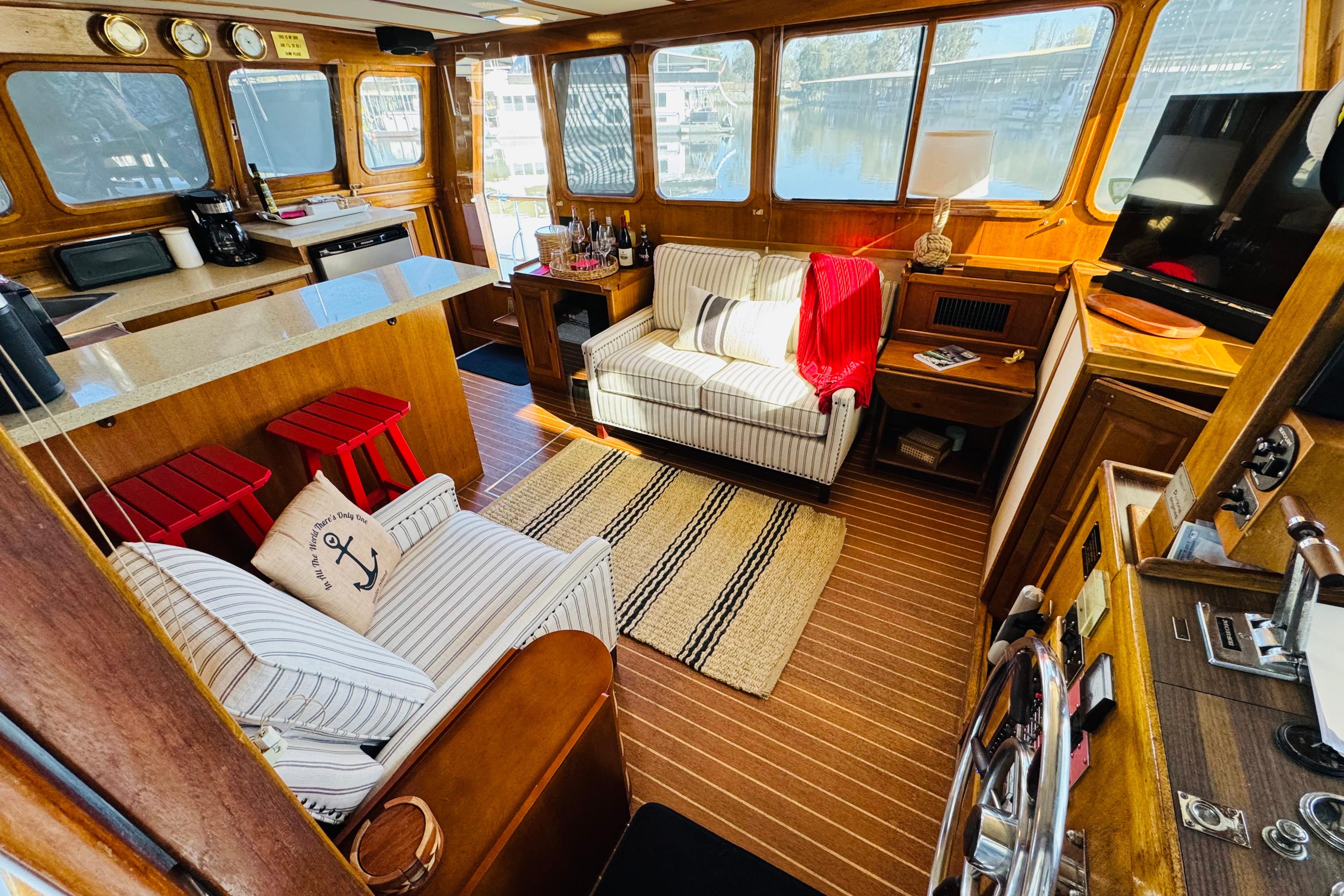 Interior of a 1978 Californian 42 LRC yacht with cozy seating and nautical decor.