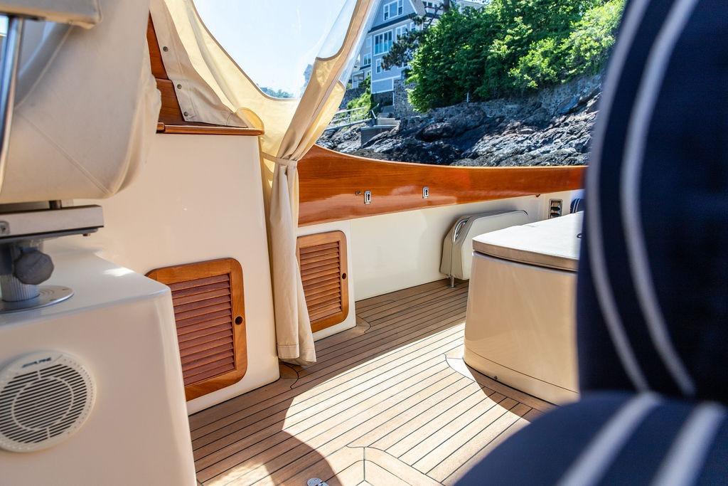 Interior of 2000 Hinckley Picnic Boat 36 Classic with wooden deck and coastal view.