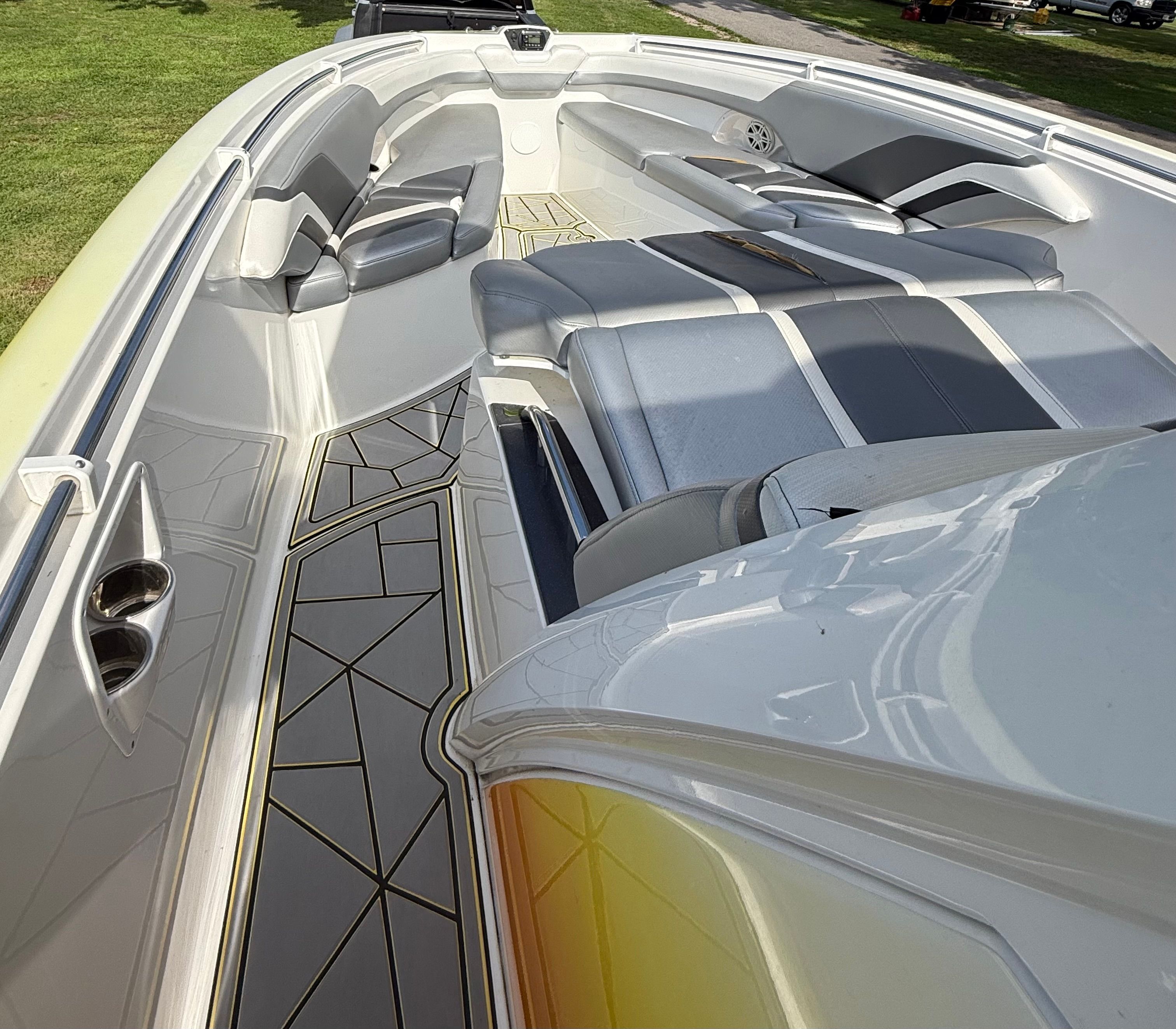 The image shows the deck of a 2014 Sunsation 34 CCX boat with sleek seating.