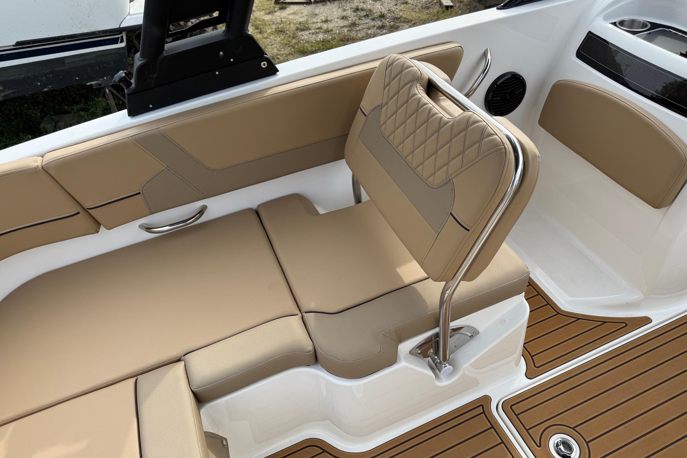 2026 Bayliner VR6 Bowrider OB interior with tan seating and wood-style flooring.
