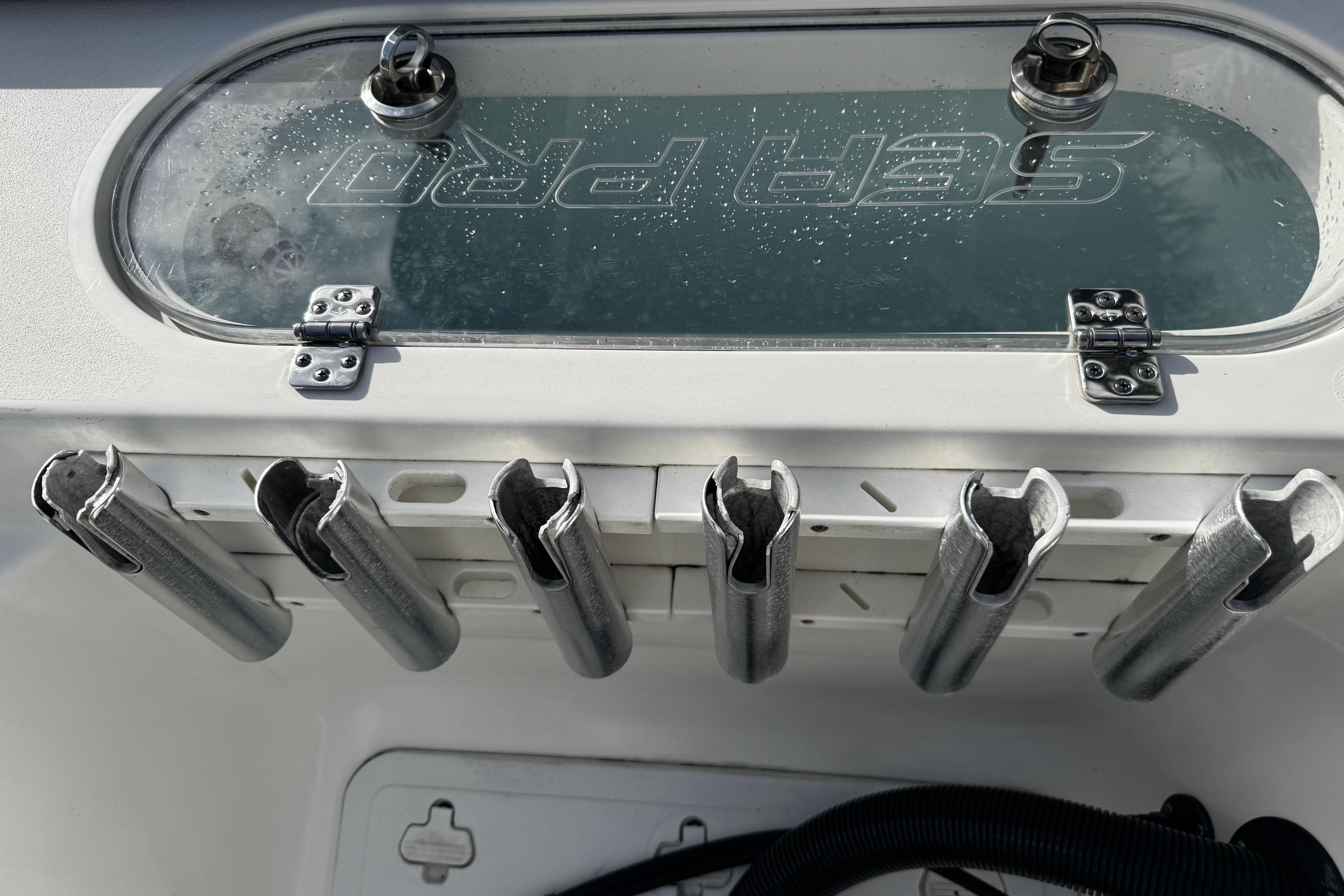 2022 Sea Pro 239 Center Console with rod holders and storage compartment.