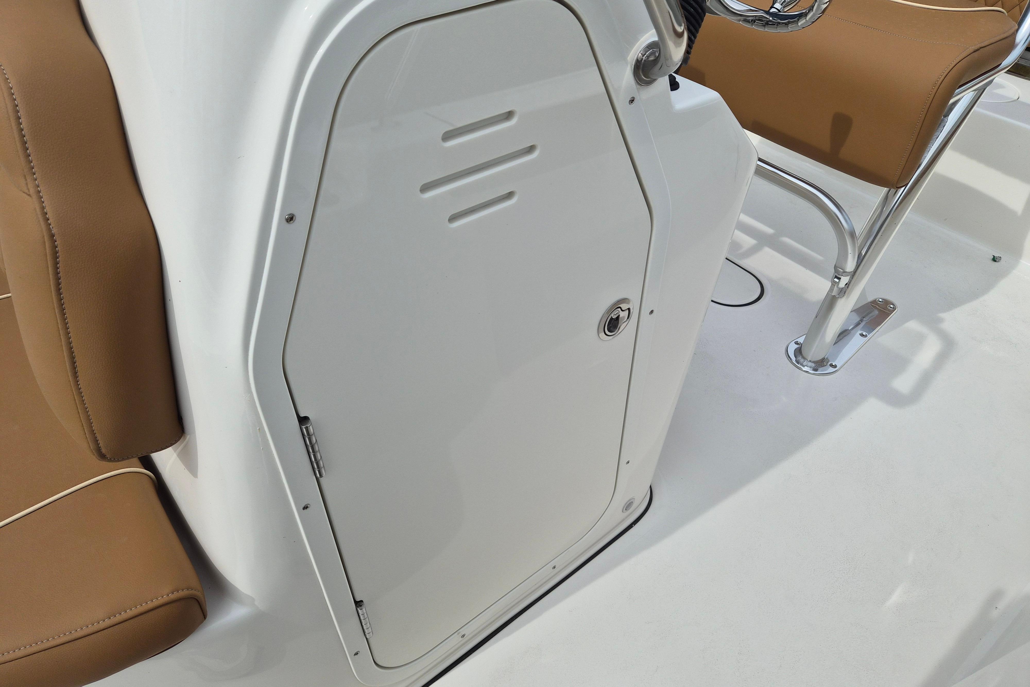 2026 Key West 189 FS boat interior with brown seating and white storage compartment.
