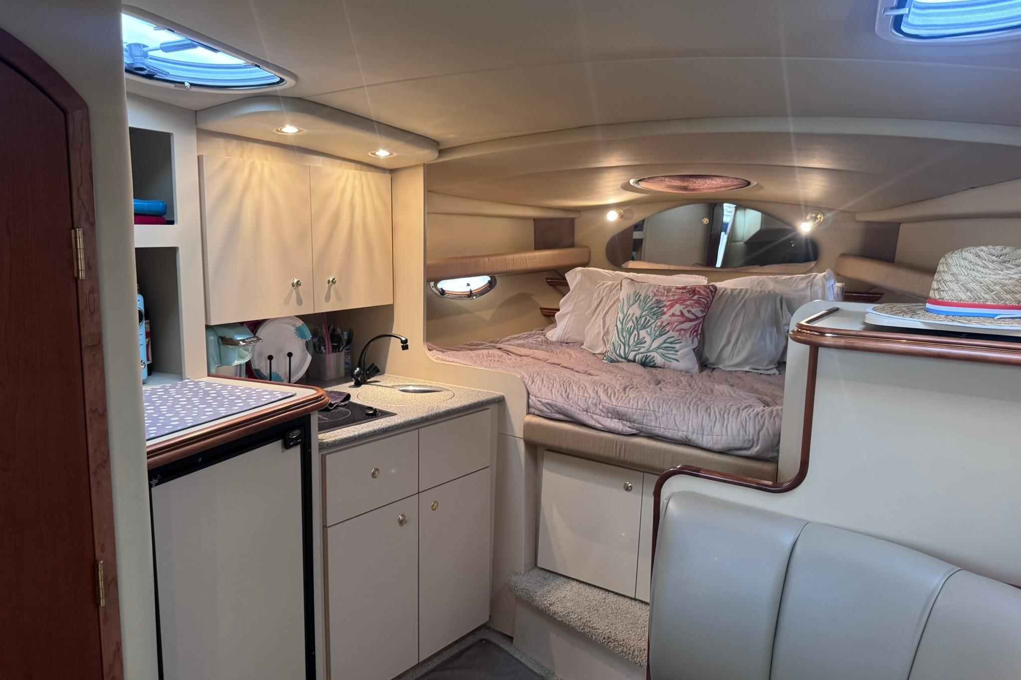 Interior of 2002 Cruisers Yachts 3275 Express with cozy bed and kitchenette.