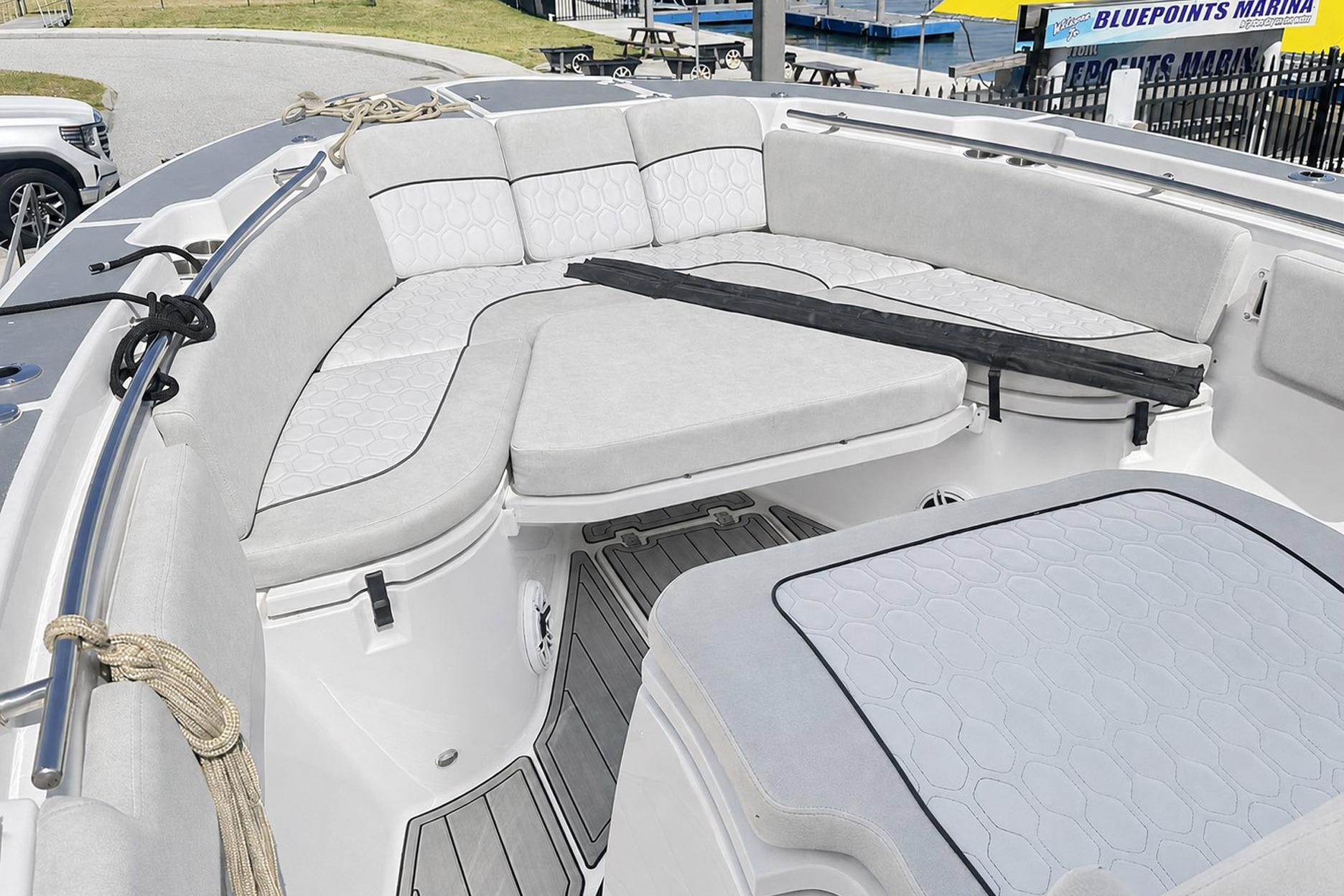 Interior view of a 2002 Sea Fox 228 Commander boat with cushioned seating.