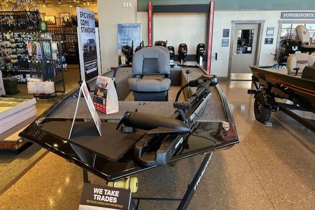 2025 Tracker Panfish 17 boat displayed in showroom, featuring comfortable seating and modern design.