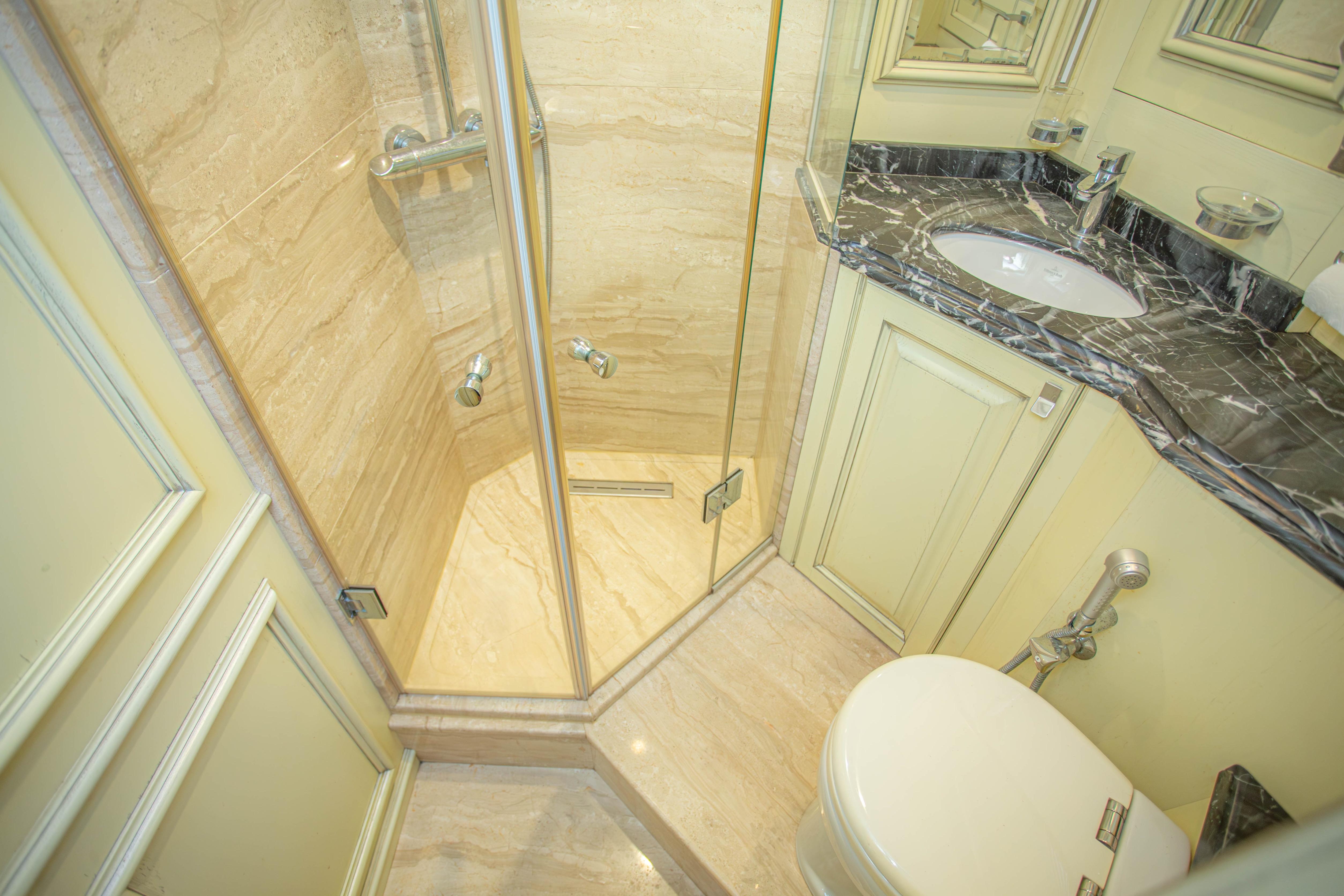 Luxurious bathroom on 2014 Fifth Ocean Yachts 24m Explorer Yacht, featuring marble finishes and modern fixtures.