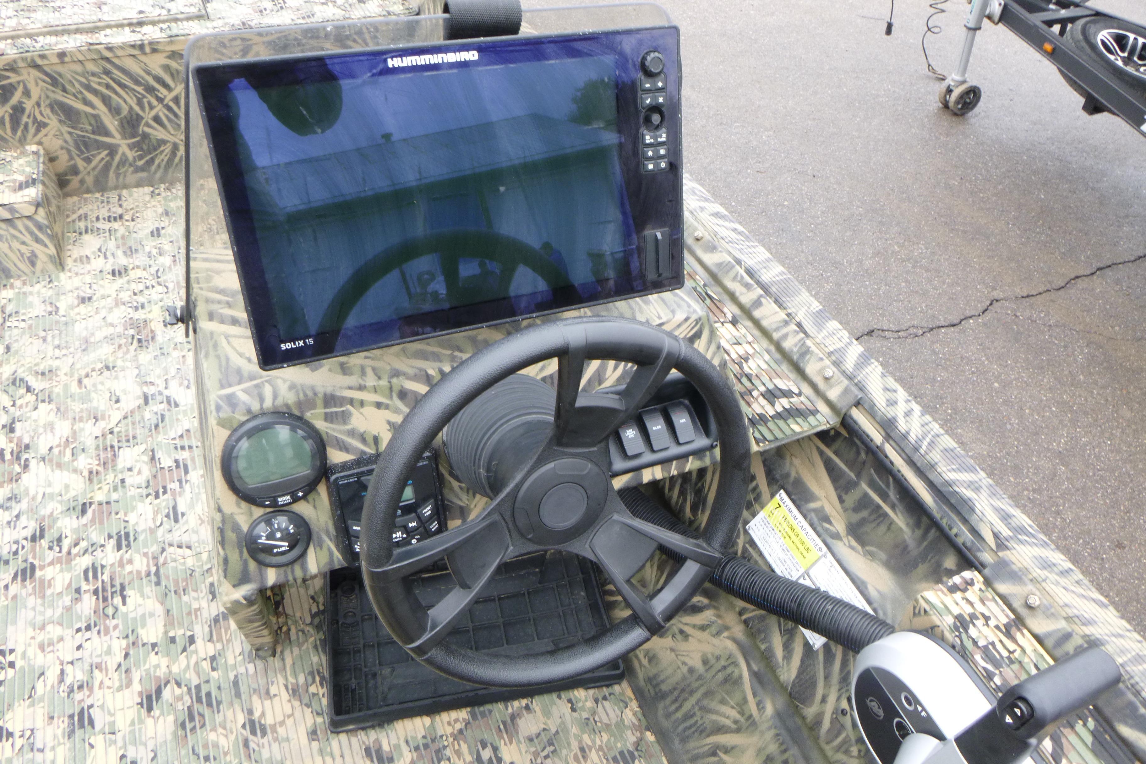 2024 Lowe Roughneck 2070 boat dashboard with steering wheel and Humminbird Solix 15 display.