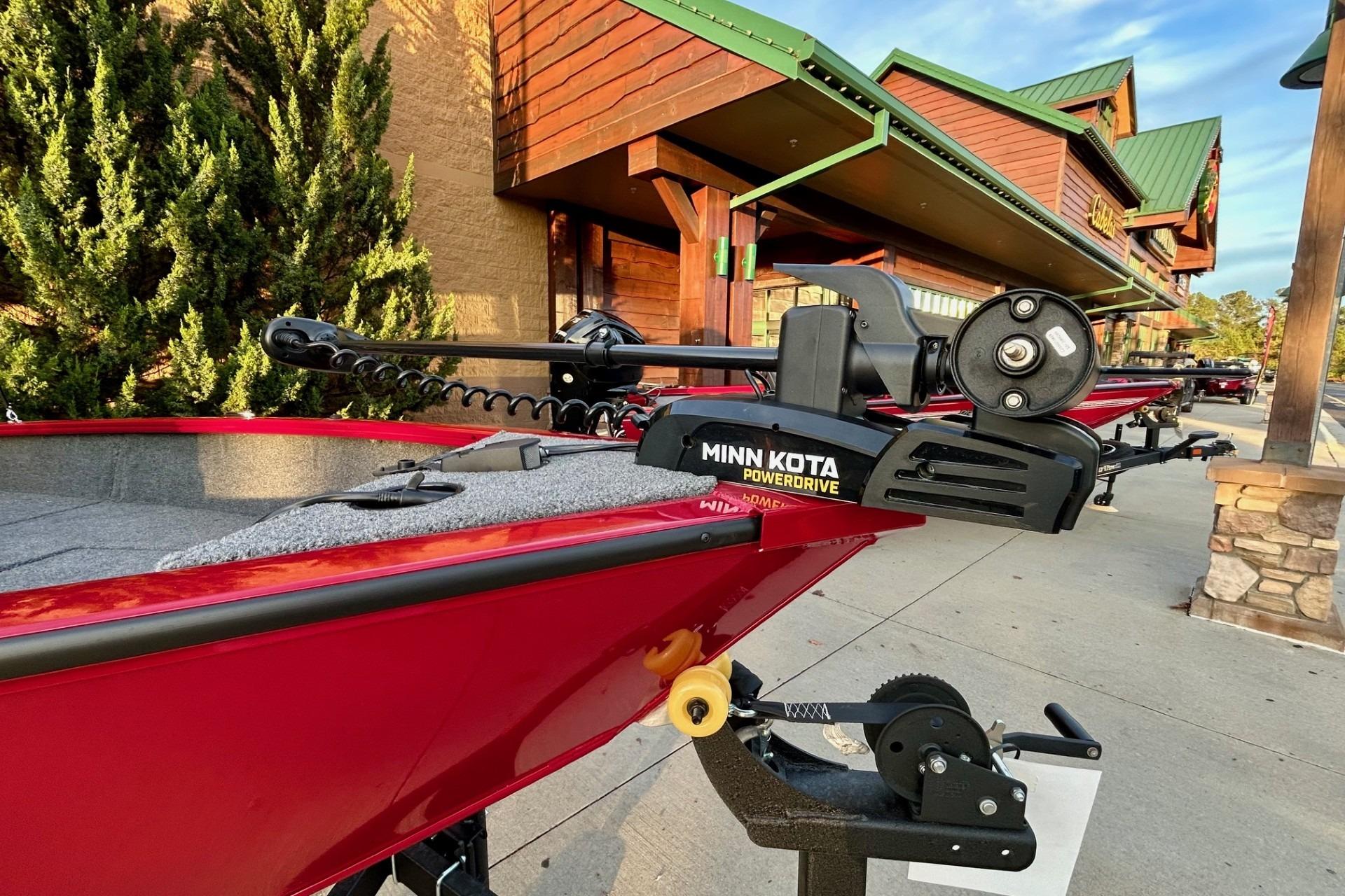 Red 2026 Tracker Super Guide V-16 SC boat with Minn Kota PowerDrive motor.