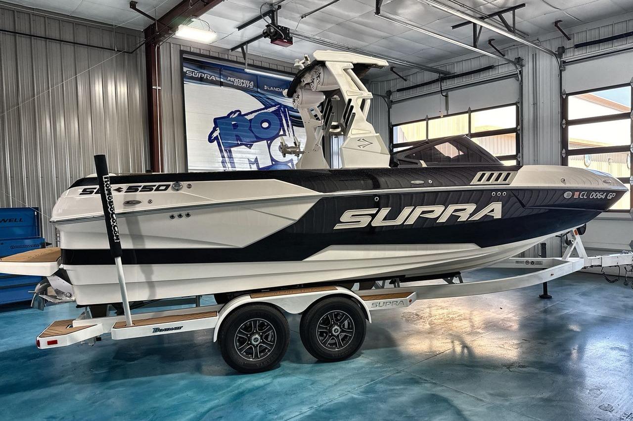 2020 Supra SE boat on trailer in indoor showroom setting.