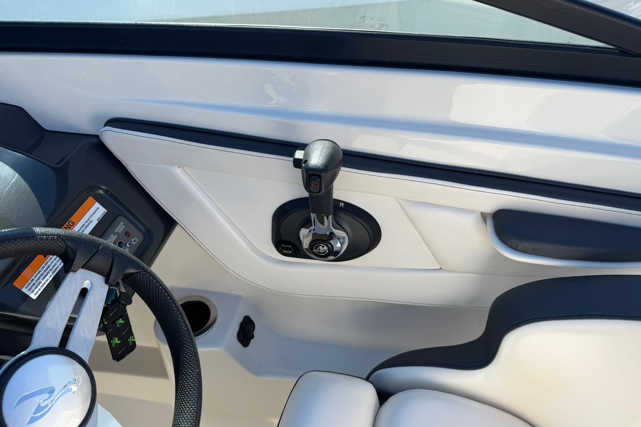 Interior view of a 2016 Sea Ray SPX 210 boat cockpit with steering wheel and controls.