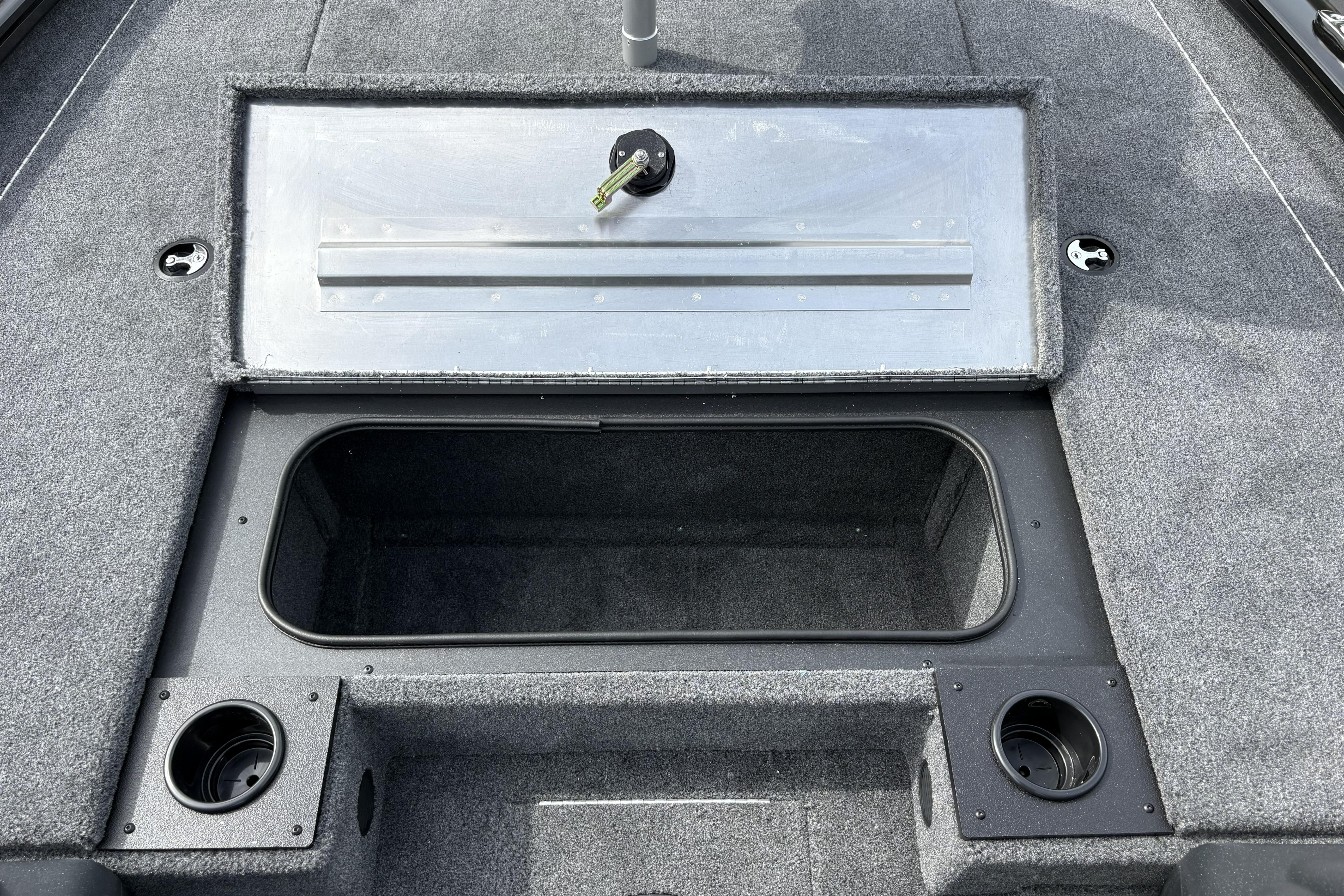 2026 Tracker Pro Team 195 boat interior with open storage compartment and cup holders.