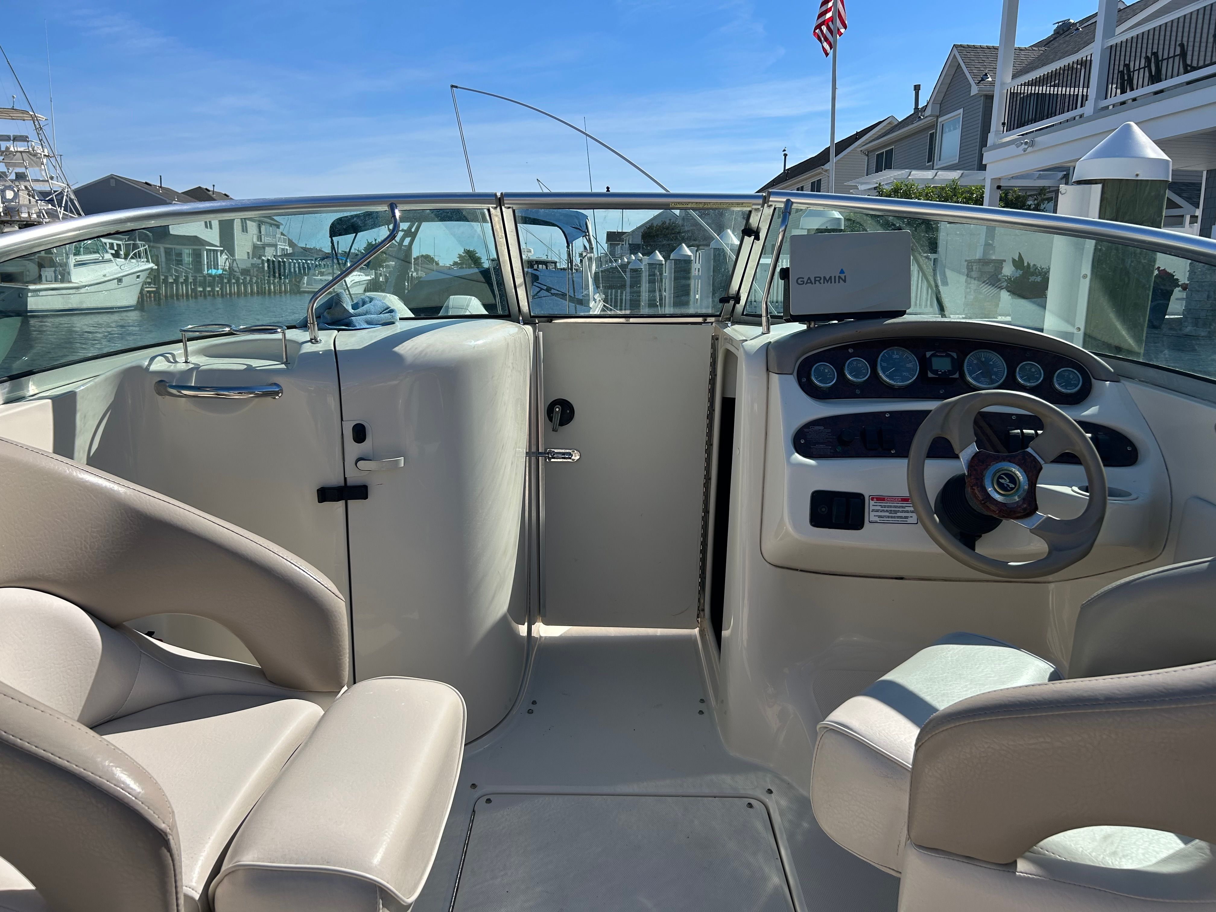 Interior view of a 2003 Sea Ray 240 Sundeck boat at dock.