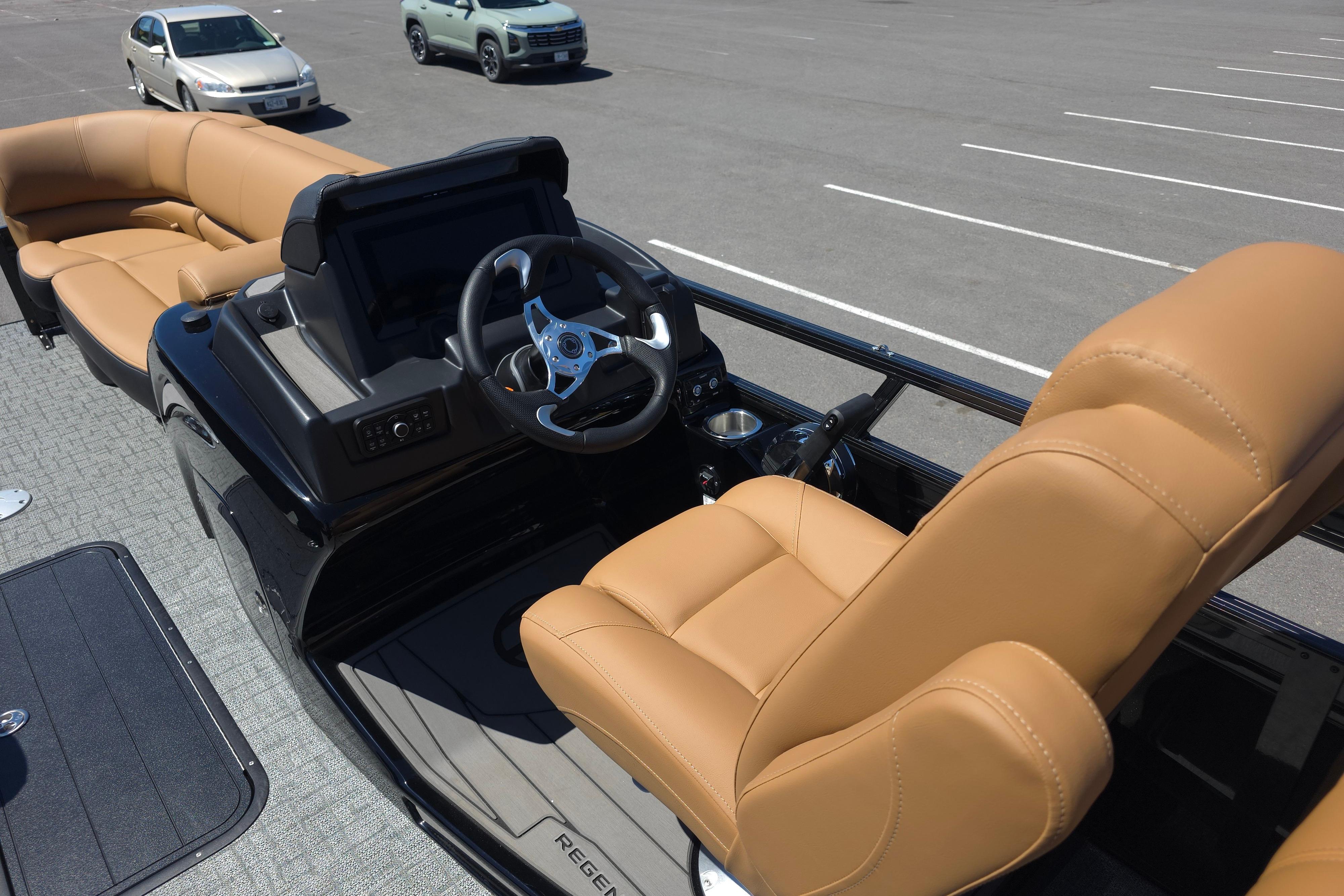 Luxurious 2026 Regency 230 DL boat interior with tan leather seating and modern dashboard.