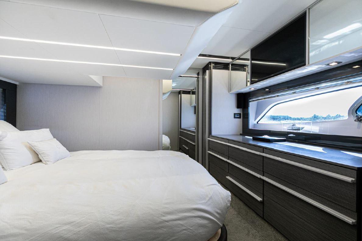 Luxurious bedroom interior of 2018 Pershing 5x yacht with modern design and ample storage.