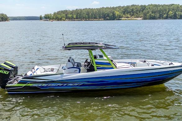 2024 Sunsation 32 CCX boat on a lake, featuring sleek design and vibrant colors.