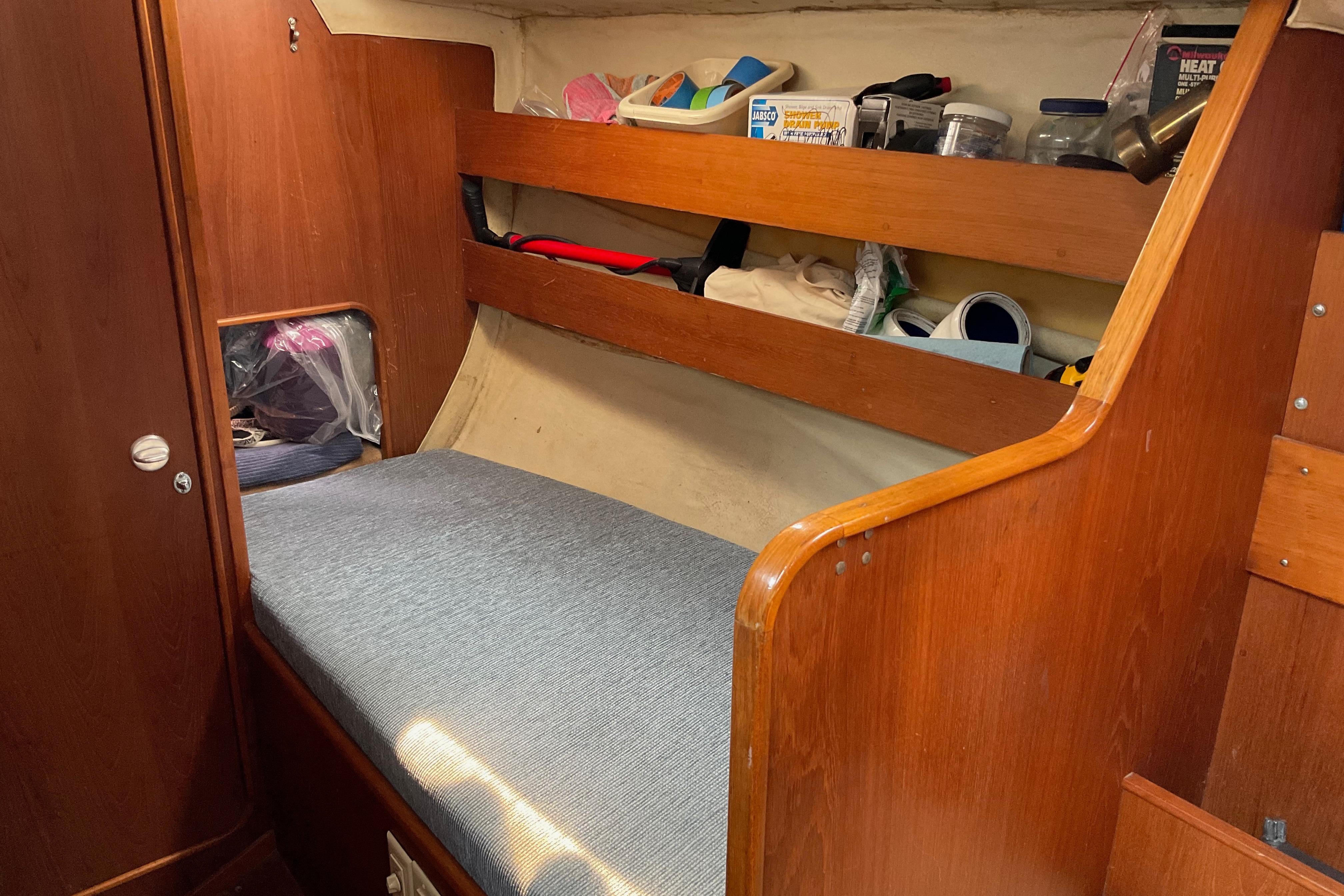 Cozy cabin interior of 1988 Westerly Corsair 36 sailboat with wooden furnishings.