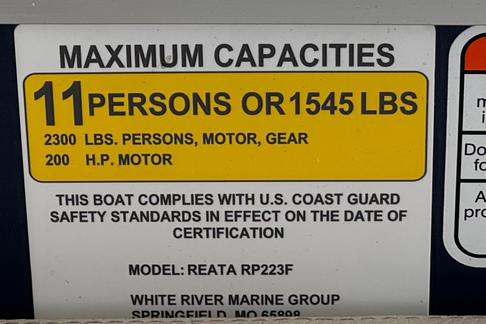 2024 Ranger Reata 223F capacity label: 11 persons or 1545 lbs, 200 HP motor.