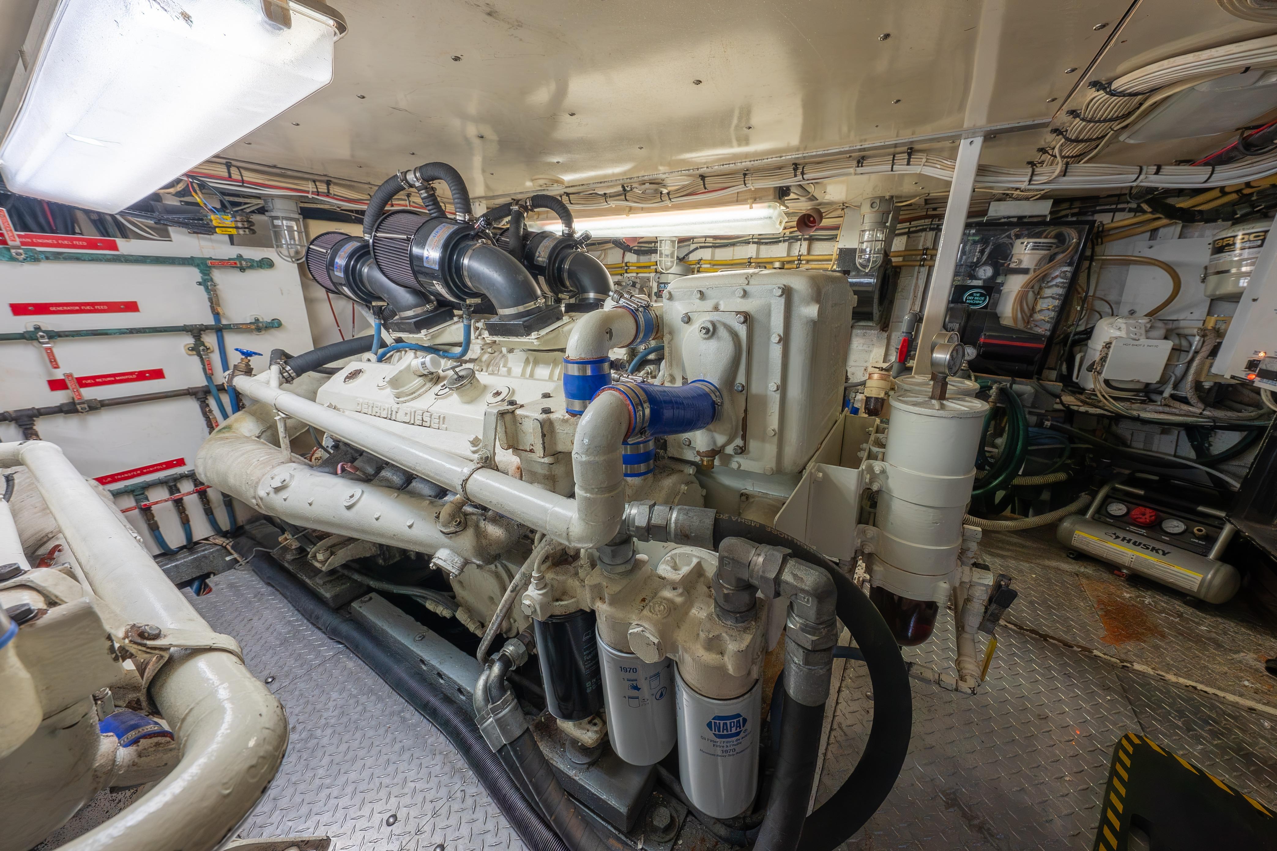 Engine room of a 1963 Trumpy Classic yacht with detailed machinery and piping.