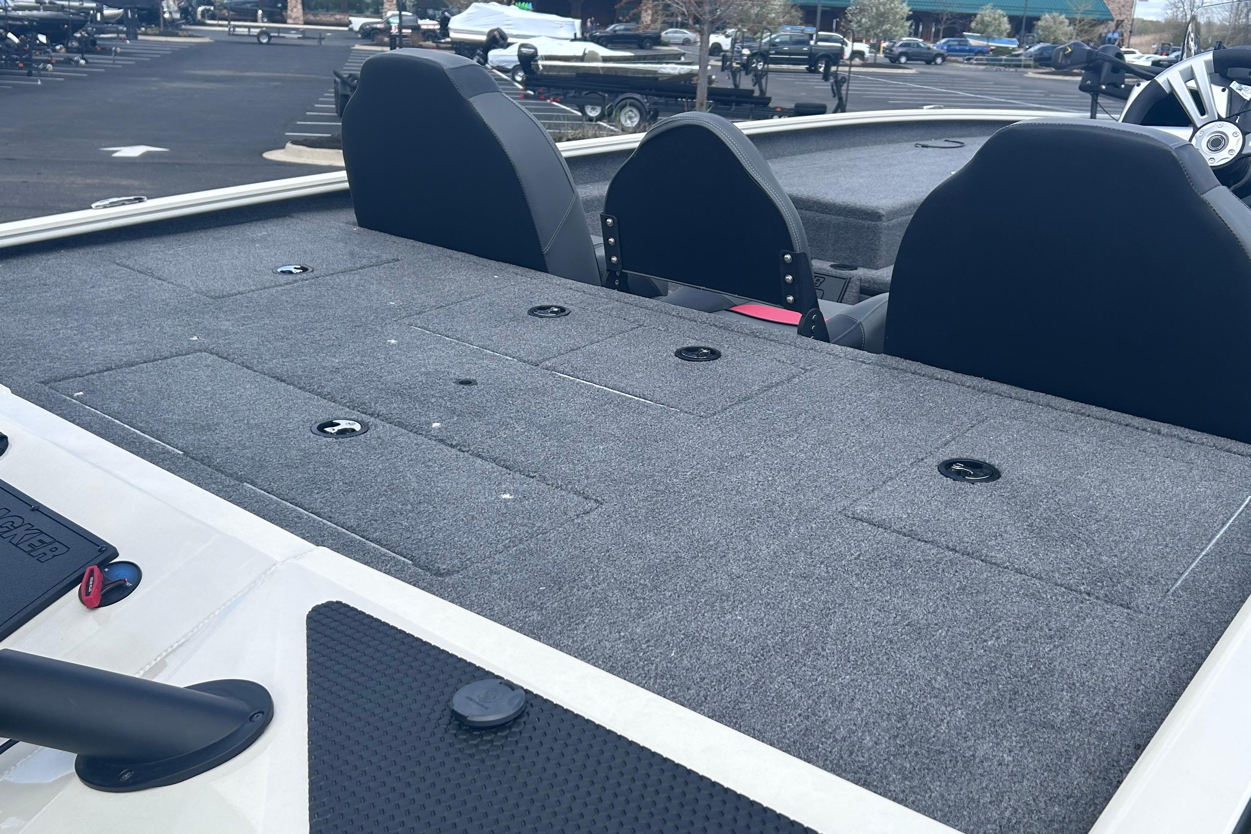 2025 Tracker Savage 215 boat interior with carpeted deck and seating.