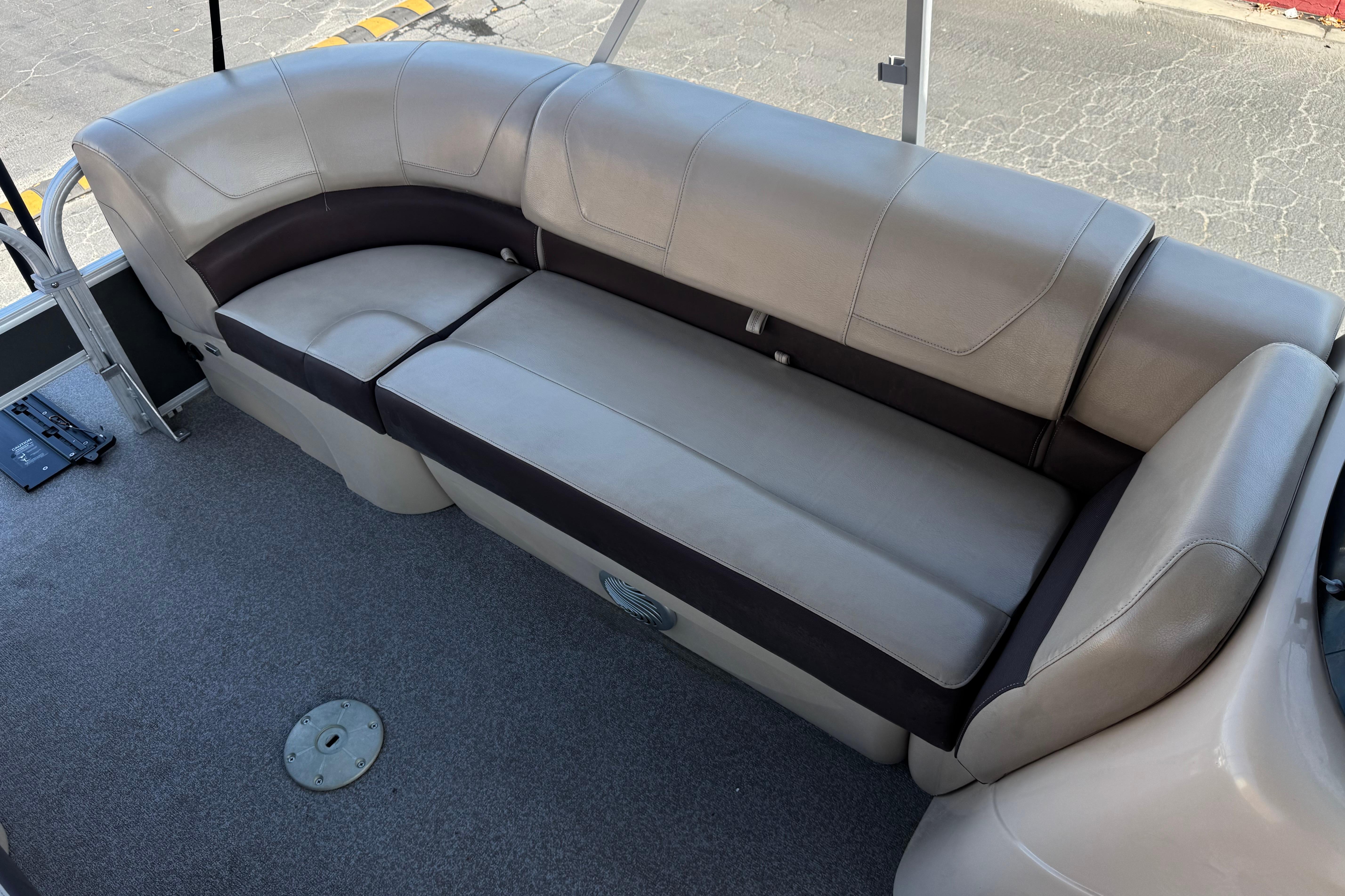 2018 Sun Tracker SportFish 22 DLX boat interior with beige seating and carpeted floor.