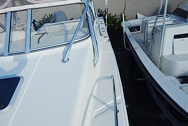 2003 World Cat 270 EC boat deck with railing and cockpit view.