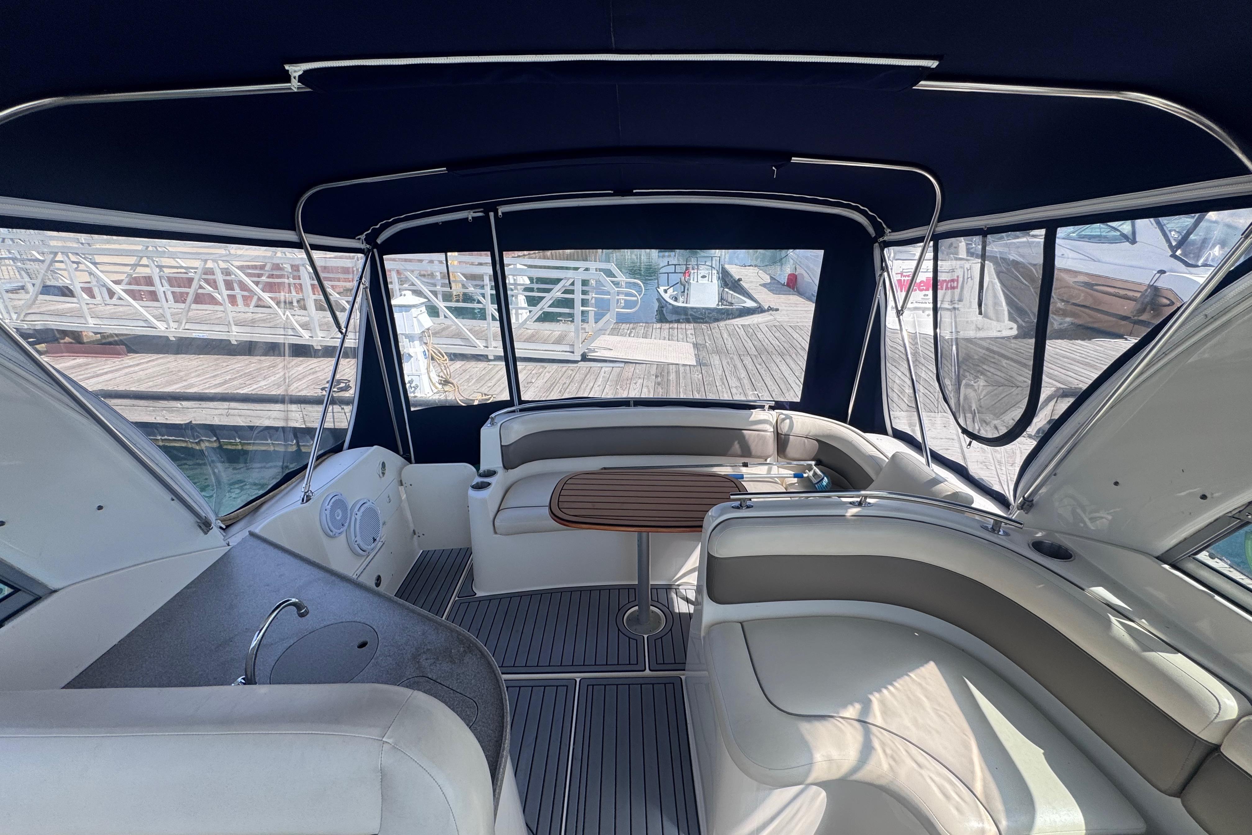 Interior of 2003 Rinker Fiesta Vee 312 boat with seating and table.