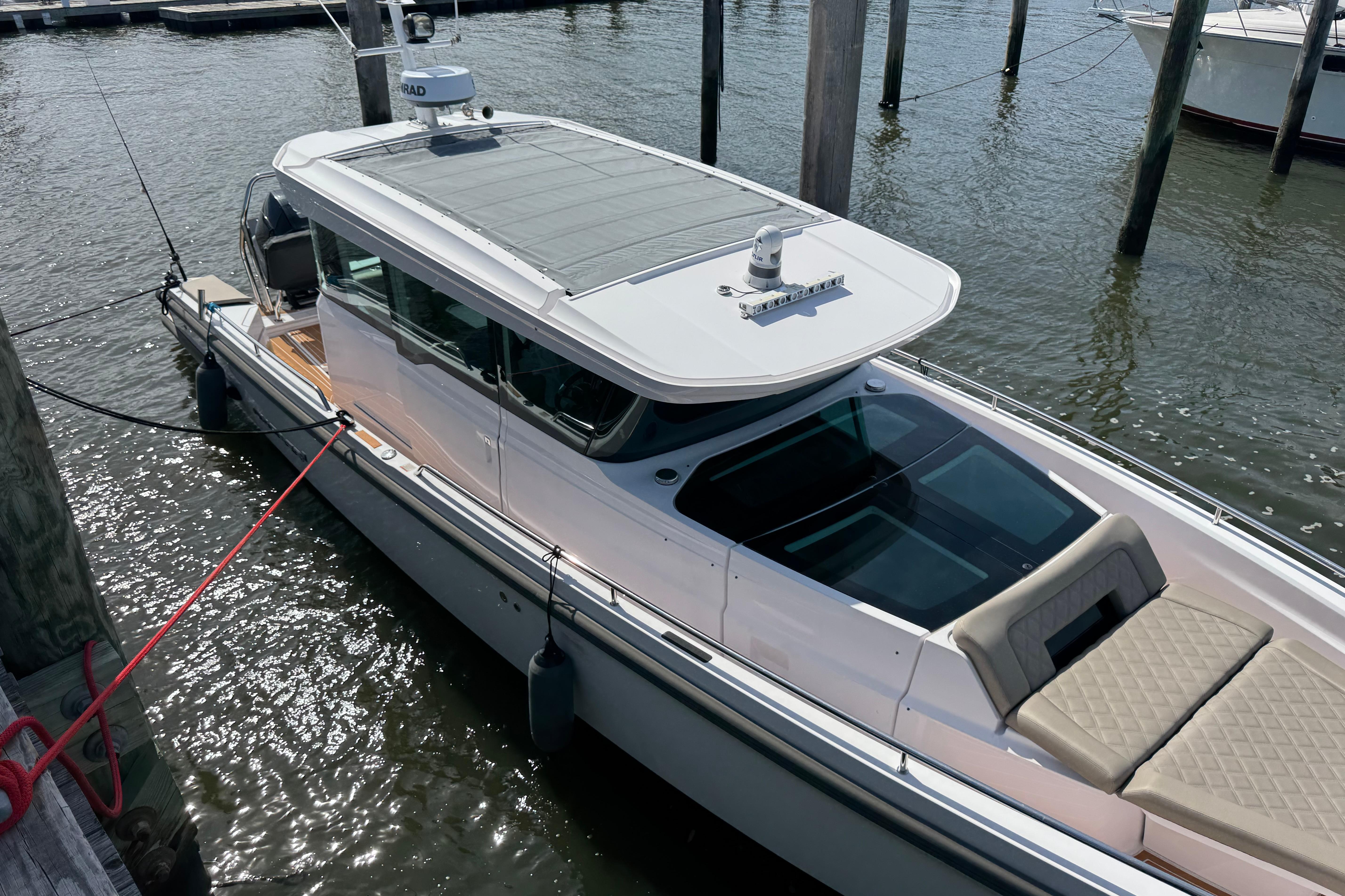 2022 Axopar 37 XC CROSS CABIN boat docked in marina, top view.