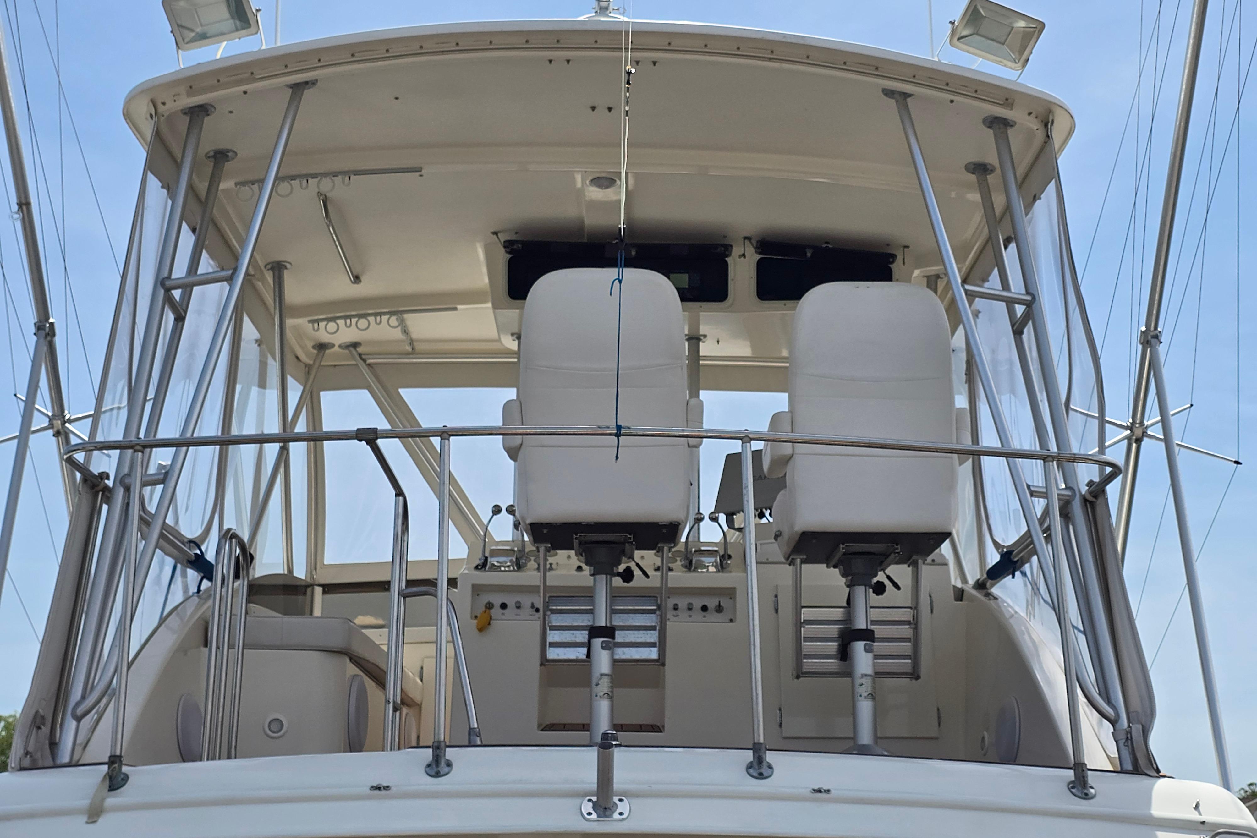 1988 Post 46 Convertible yacht helm with dual captain chairs and navigation equipment.