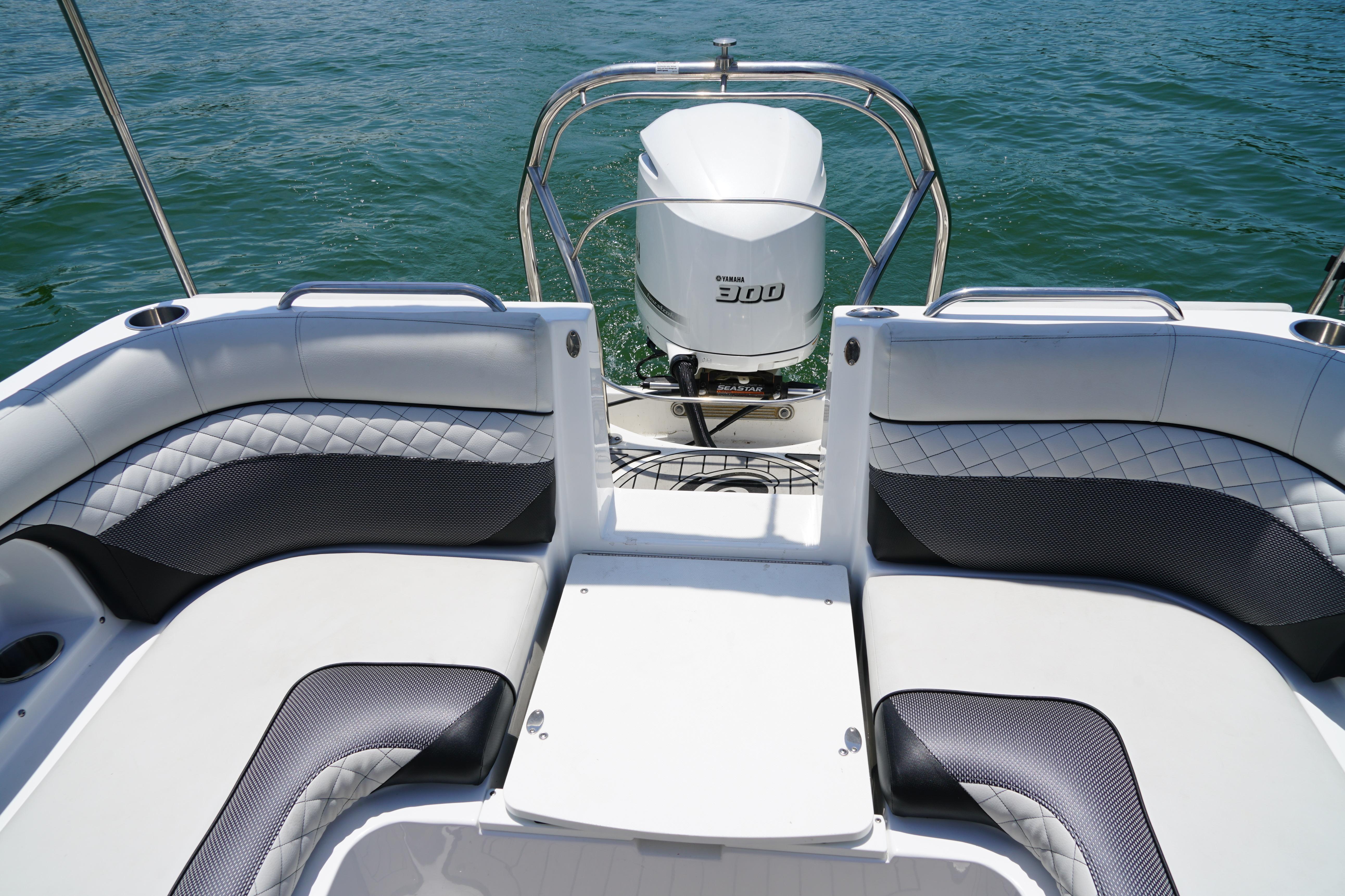 2020 Hurricane SunDeck 2486 OB boat with Yamaha 300 engine on water.