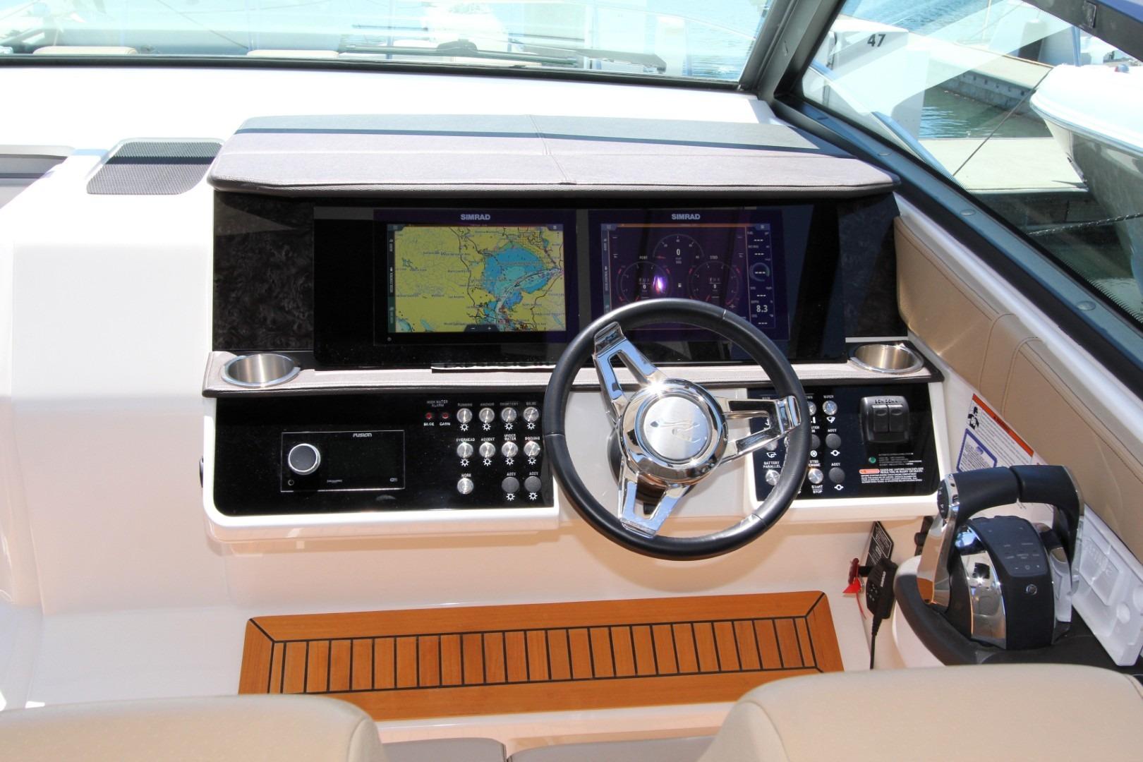 2021 Sea Ray Sundancer 320 Outboard helm with navigation screens and controls.