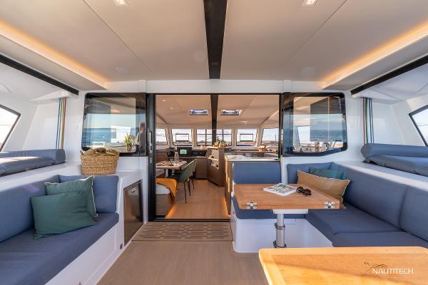 Interior of 2025 Nautitech 48 Open catamaran, featuring modern seating and dining area.