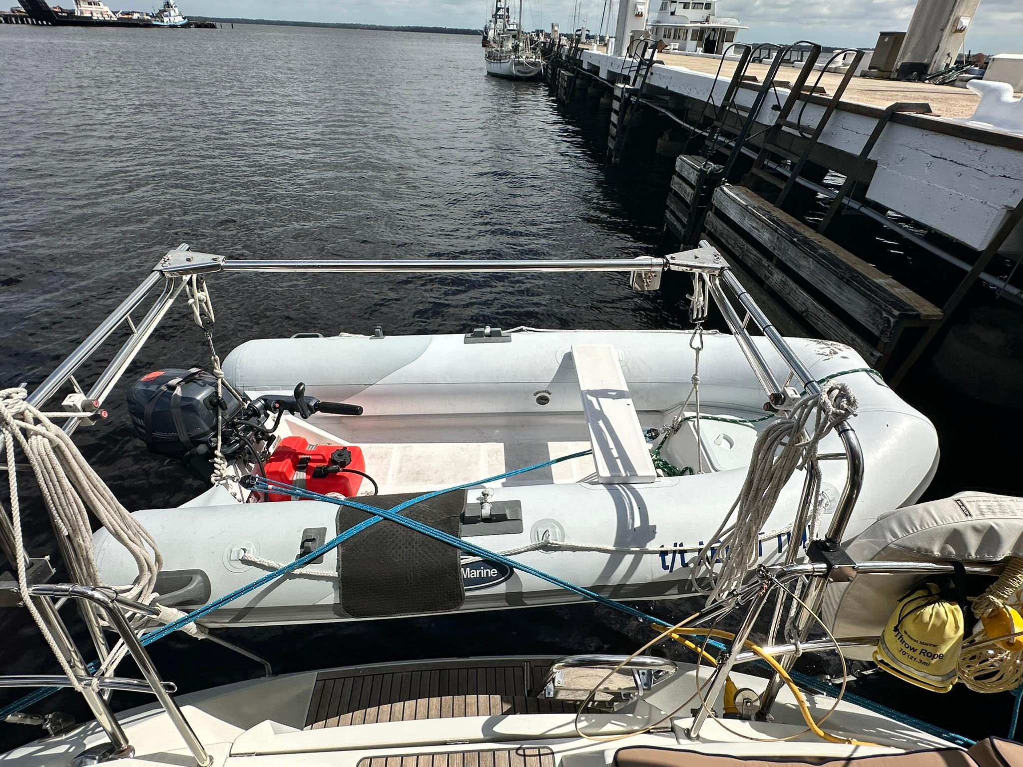 Inflatable dinghy secured on Jeanneau Sun Odyssey 45 DS, 2011 model, docked at marina.