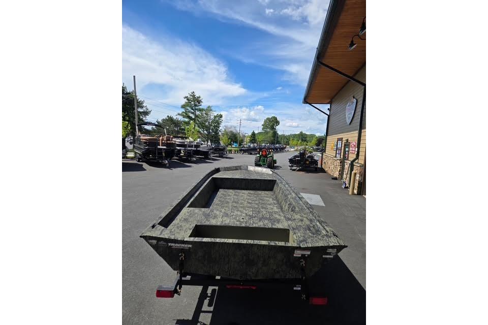 2026 Tracker Grizzly 1860 Utility boat parked outdoors on a sunny day.