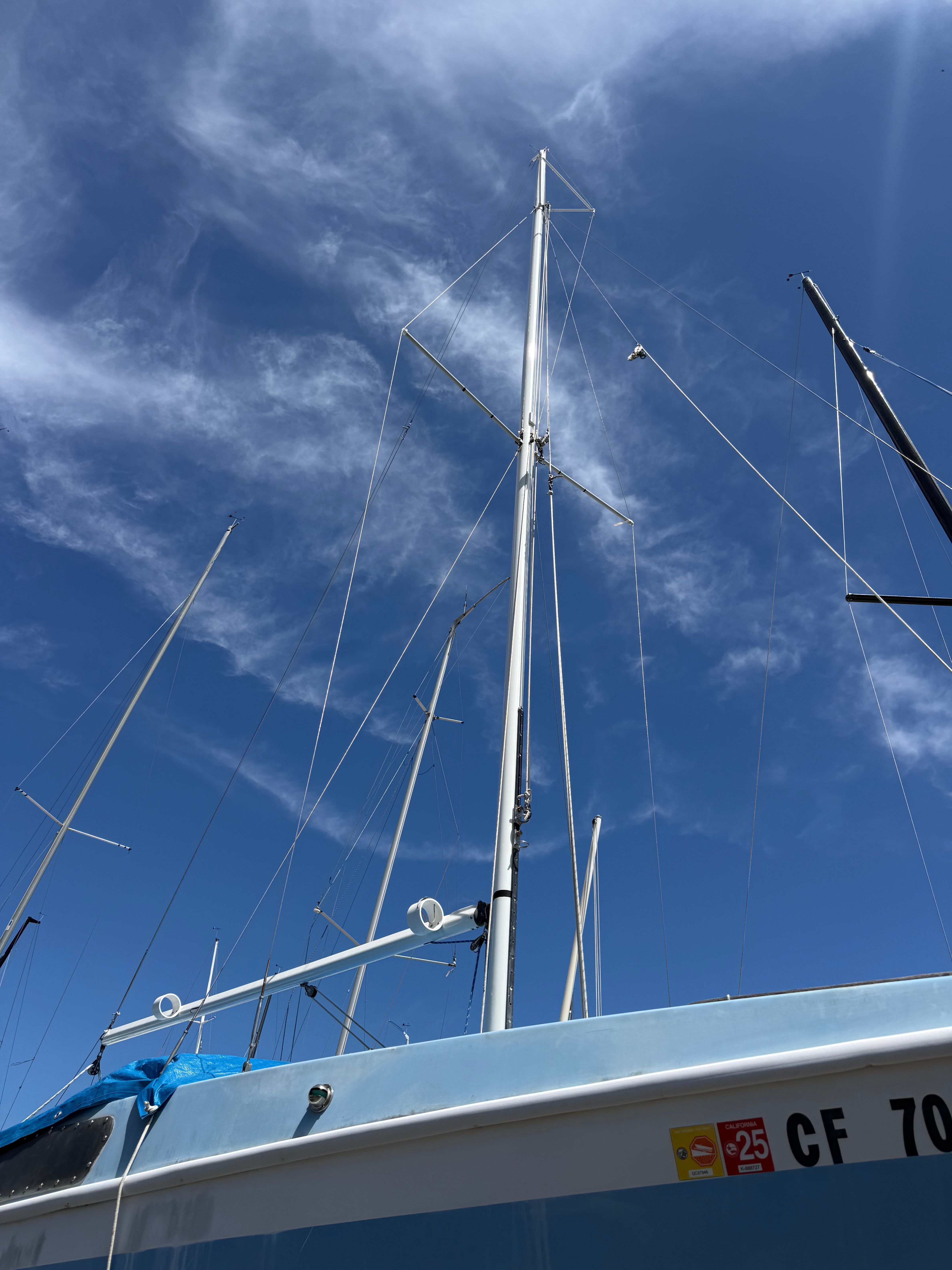 Mast of a 1965 CAL 20 sailboat against a blue sky.