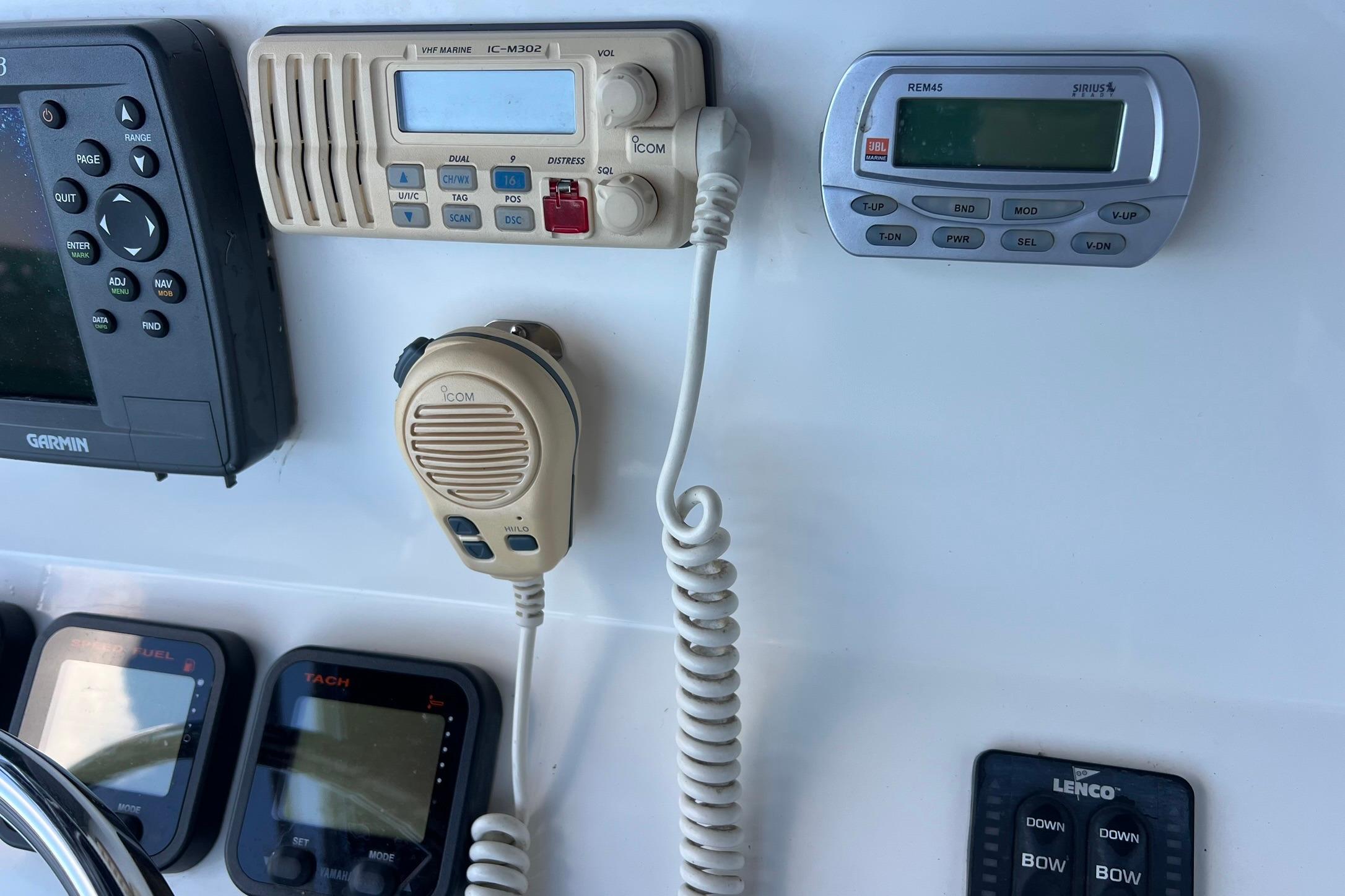 Control panel of a 2006 Edgewater 245CC boat with marine electronics and radio.
