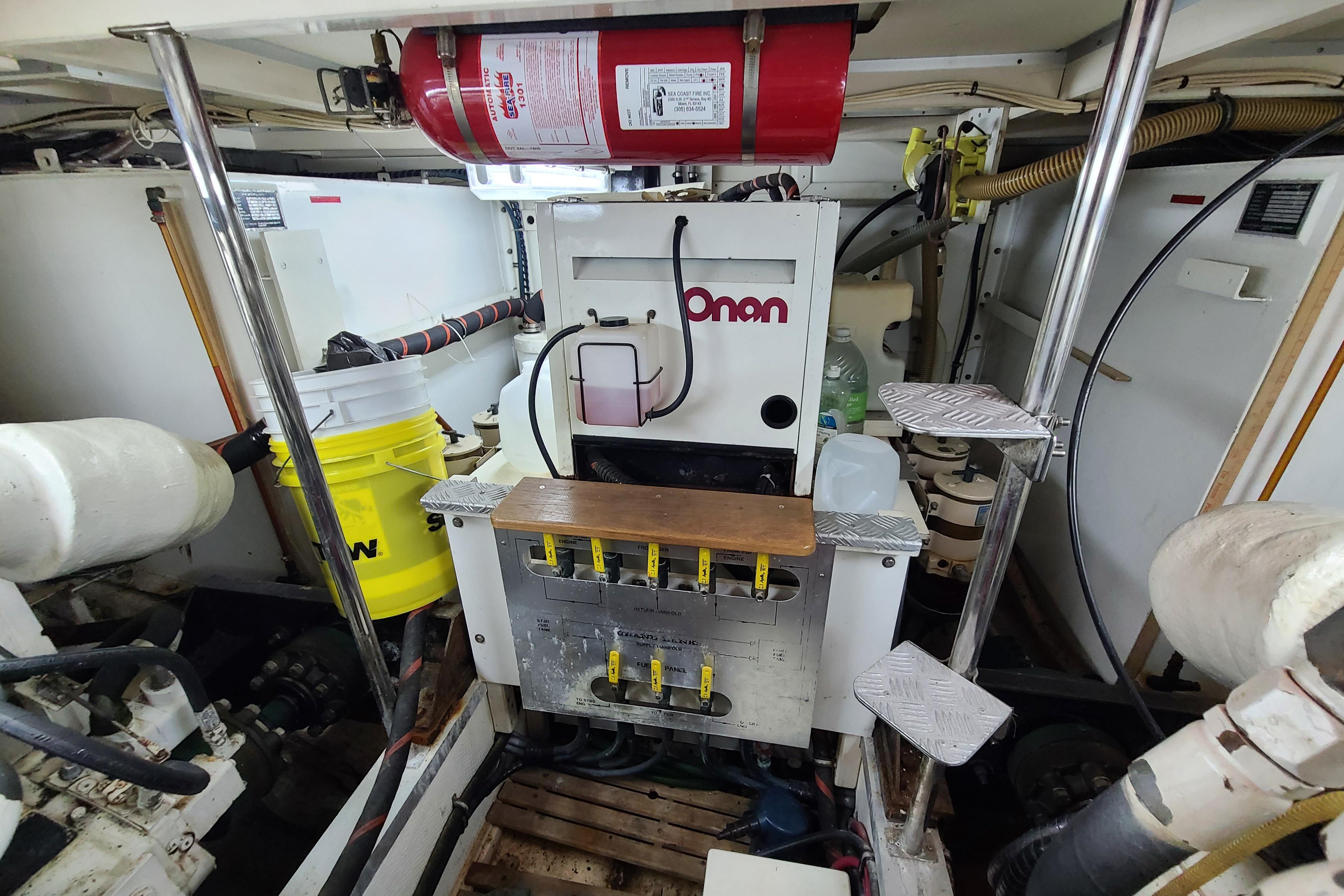 Engine room of 2000 Grand Banks 46 Classic with Onan generator and equipment.
