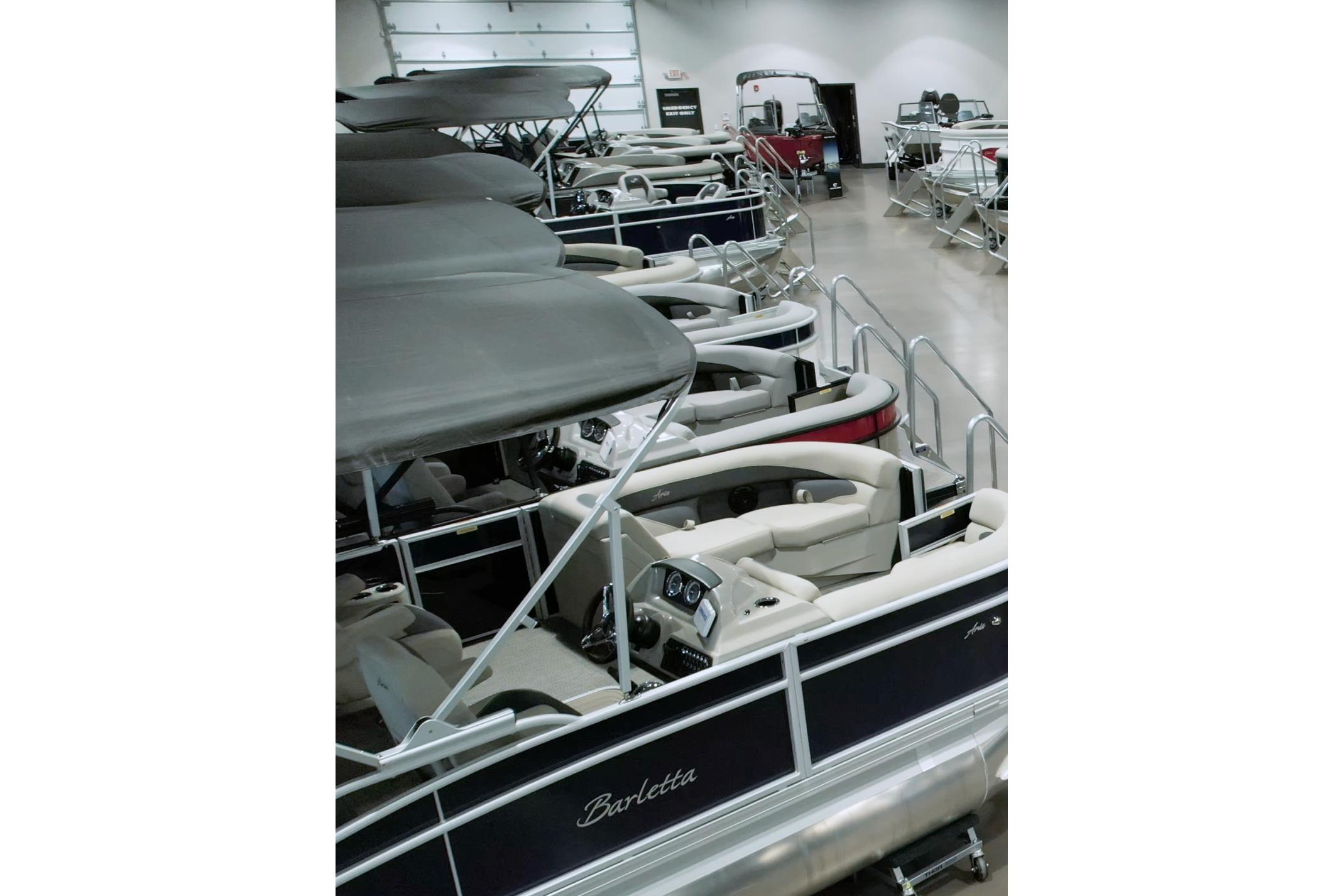2026 Barletta CORSA 23UCA pontoon boats displayed in a showroom.