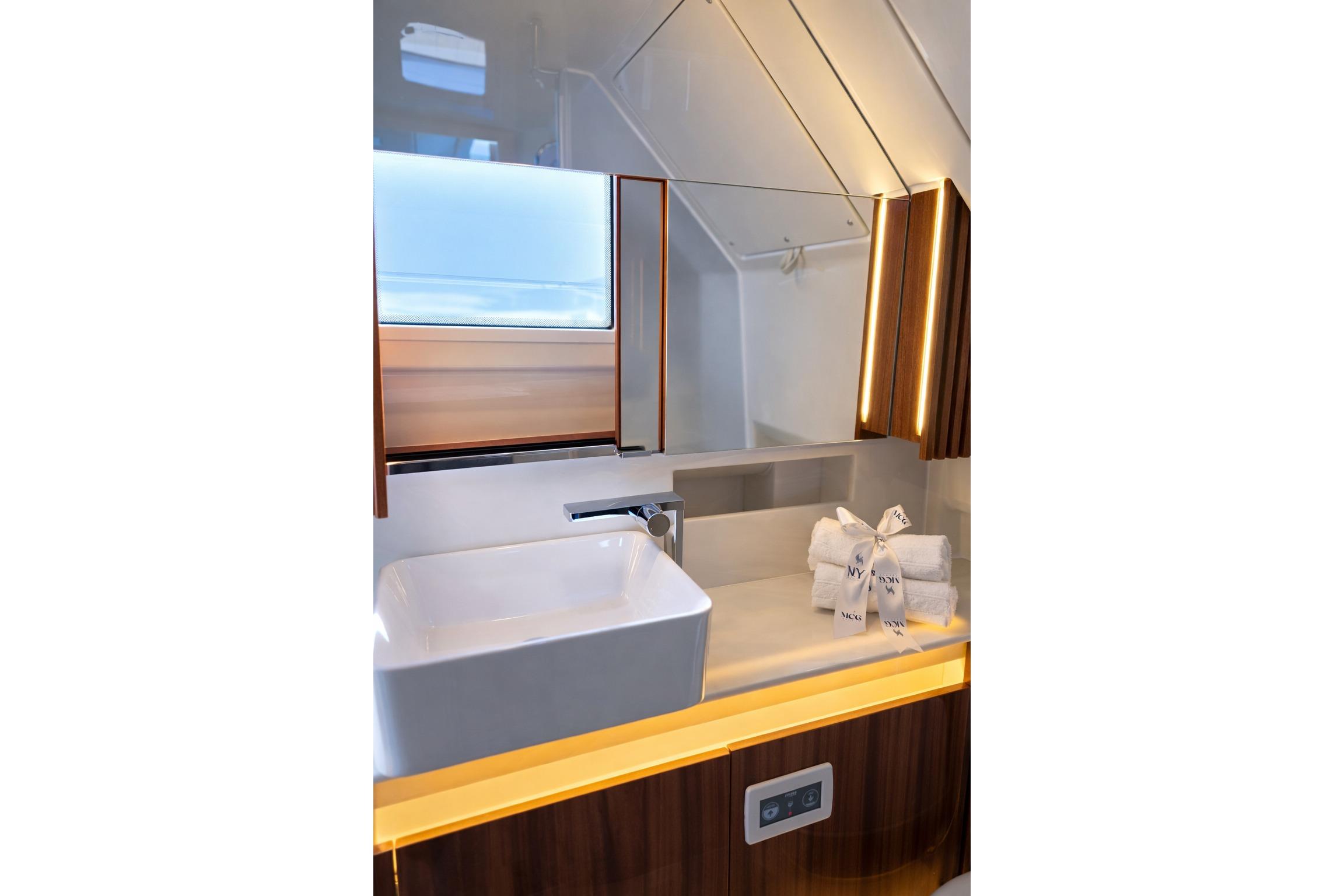 Luxurious bathroom in 2026 Wiszniewski Yachts W43, featuring modern sink and elegant lighting.