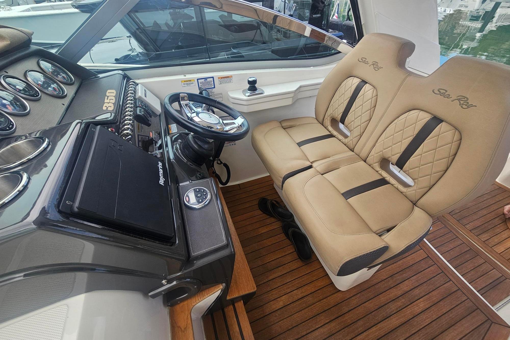 Interior of 2016 Sea Ray Sundancer 350, featuring luxurious helm and seating area.