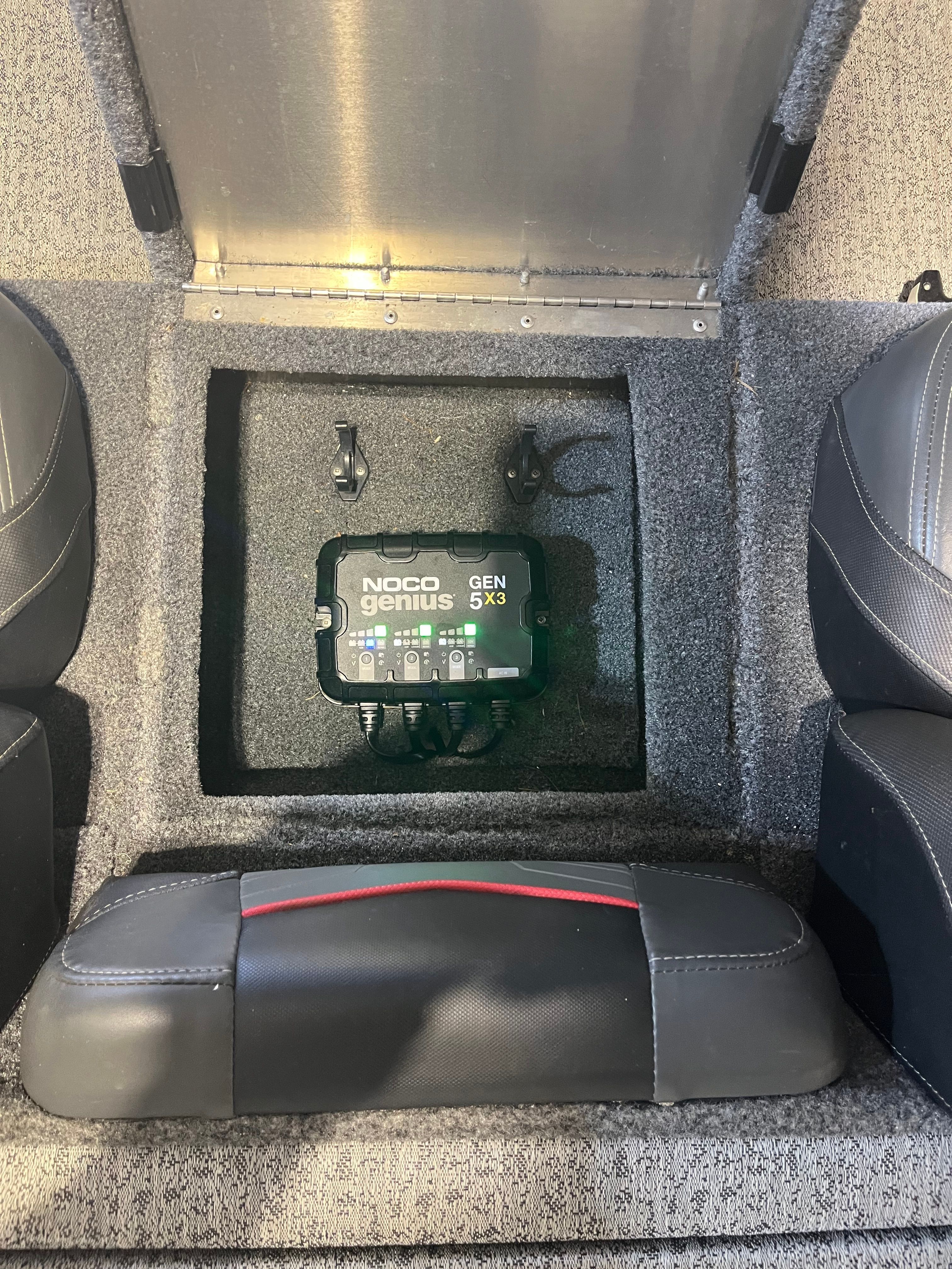A NOCO Genius GEN 5x3 charger is installed in a Bass Tracker boat.